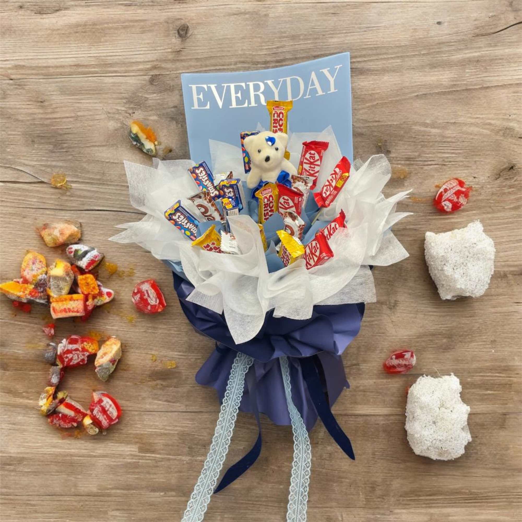 Candy bouquet with a small teddy bear and blue card