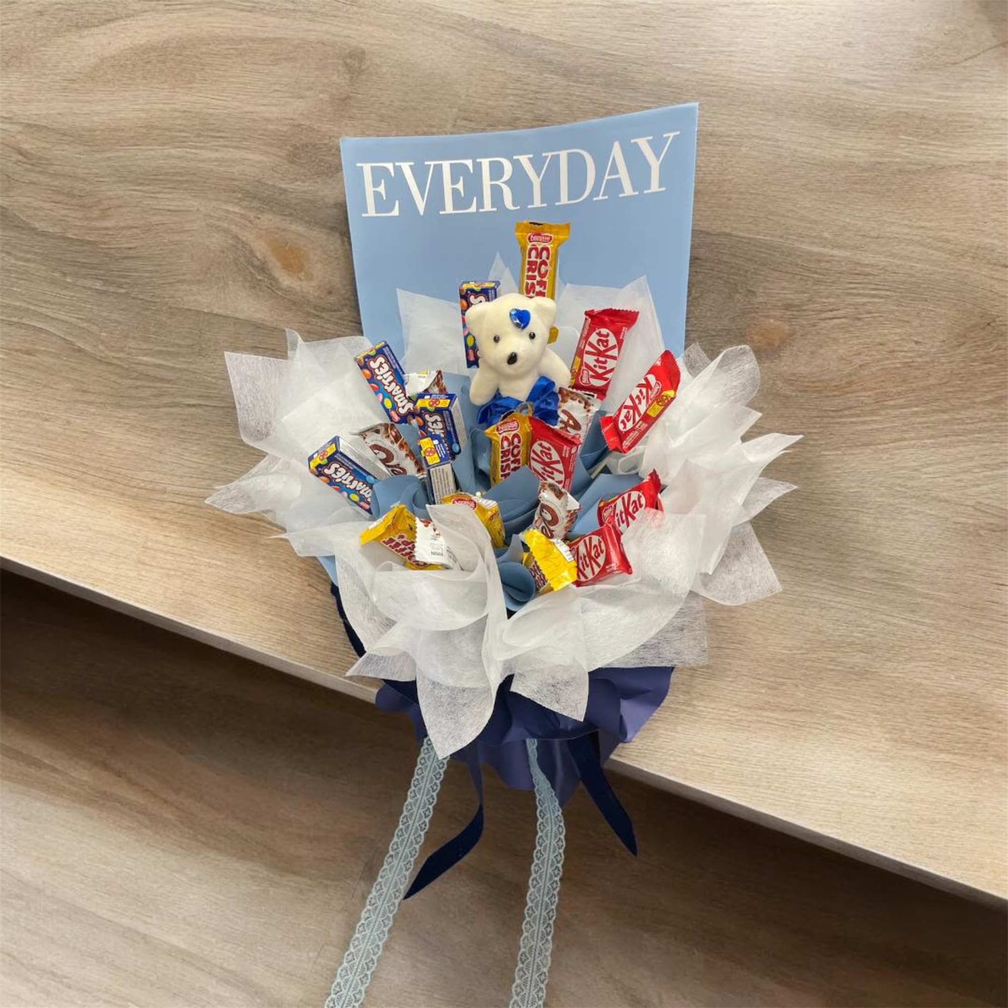 Candy bouquet with a small teddy bear and assorted chocolate bars