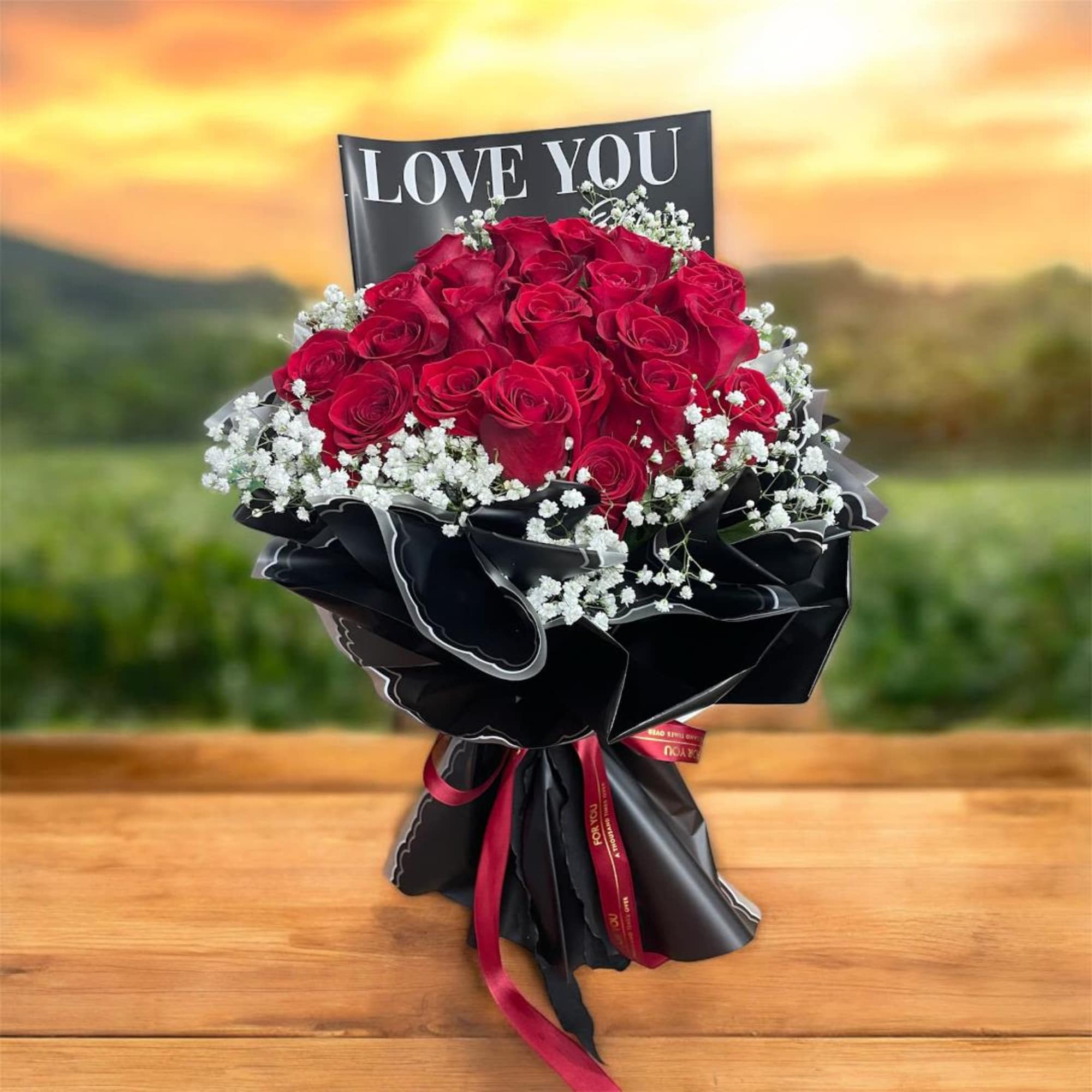 Bouquet of red roses with white baby's breath and a LOVE YOU card