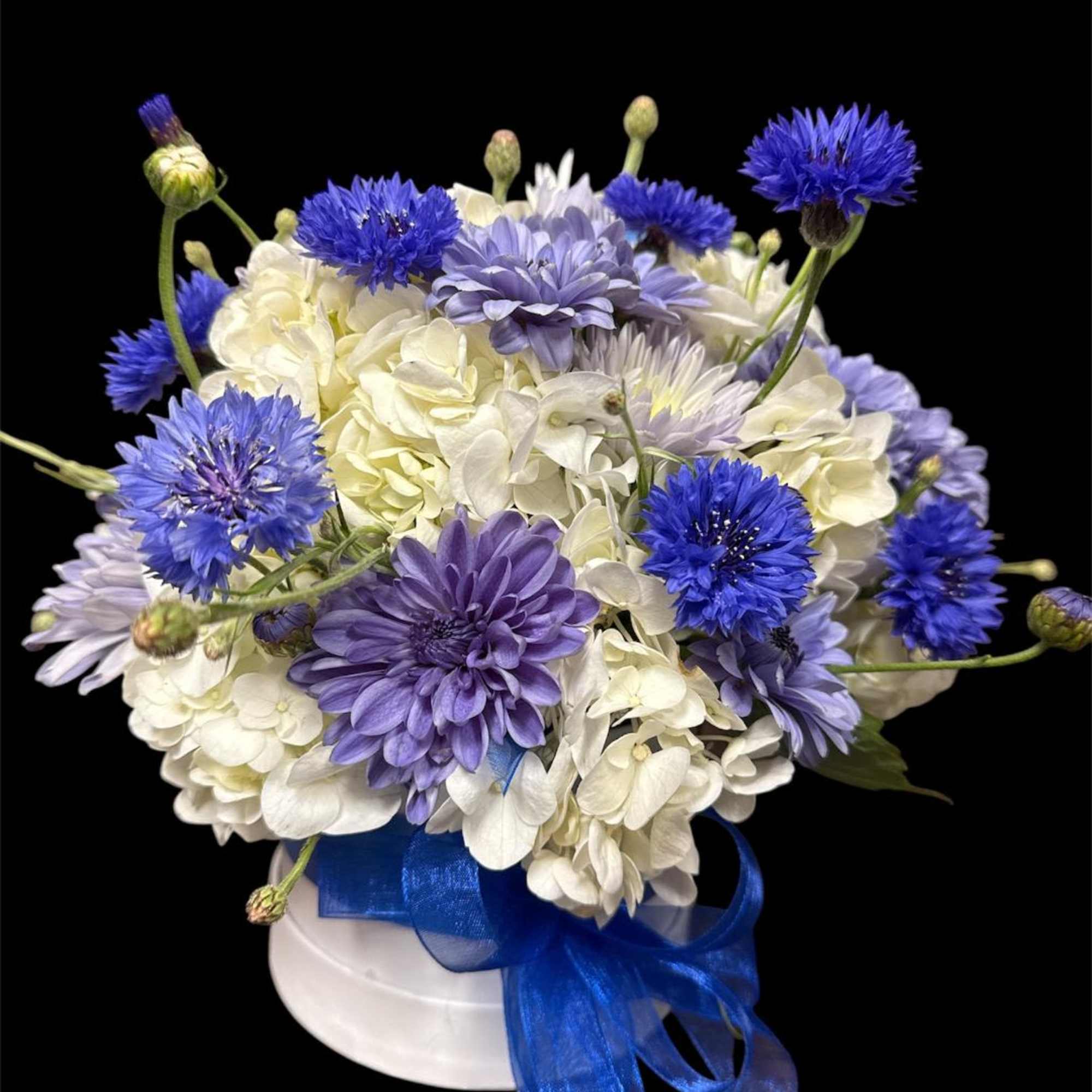Blue and white bouquet in a white hat box with a blue ribbon