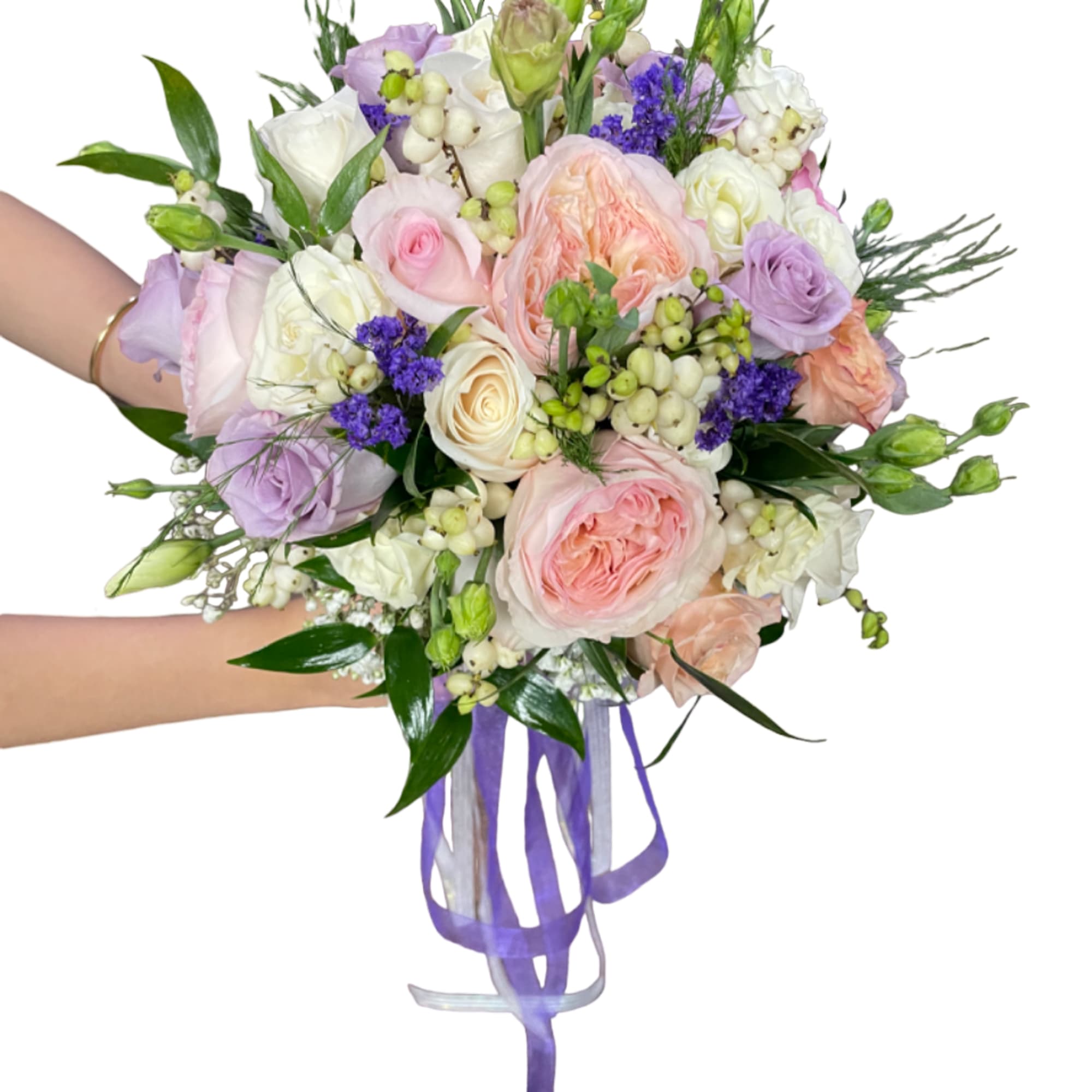 Hand-tied bouquet of pastel roses and purple flowers with ribbon tails