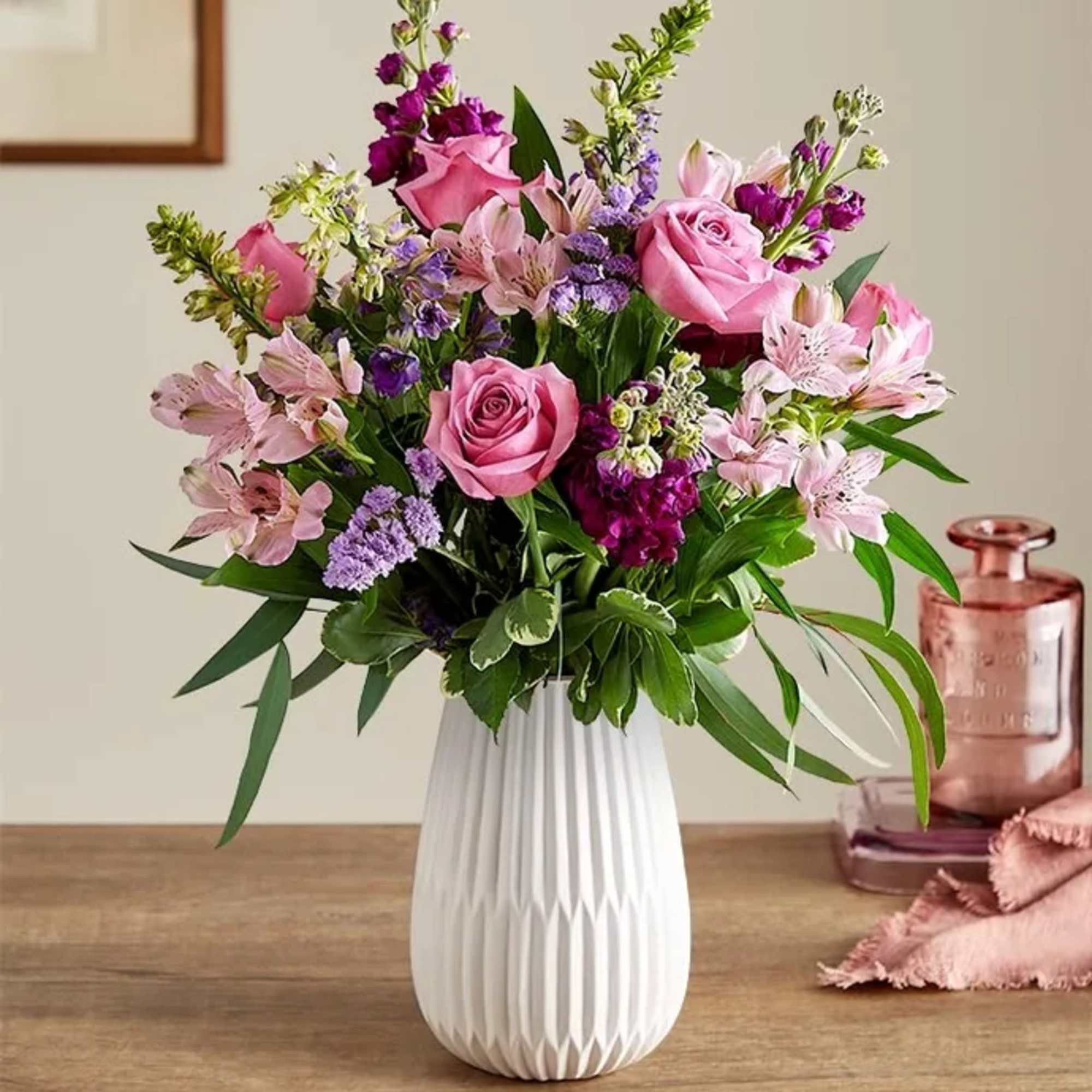 Pink and purple mixed bouquet in a white vase