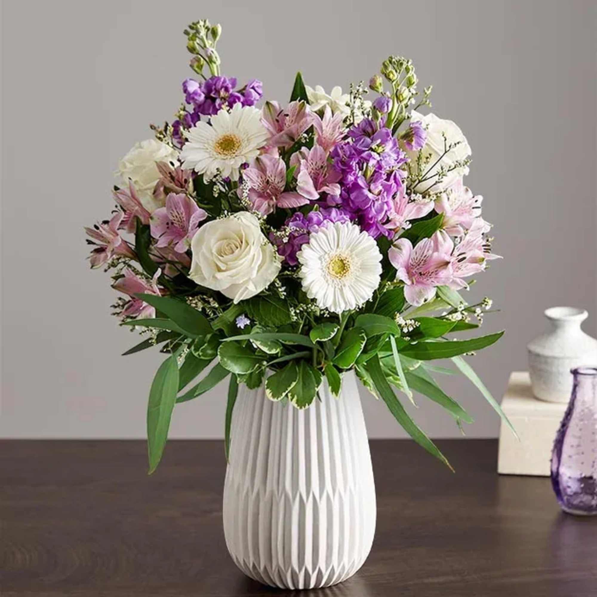 Soft lavender stock and crisp white roses mingle with lavender alstroemeria in