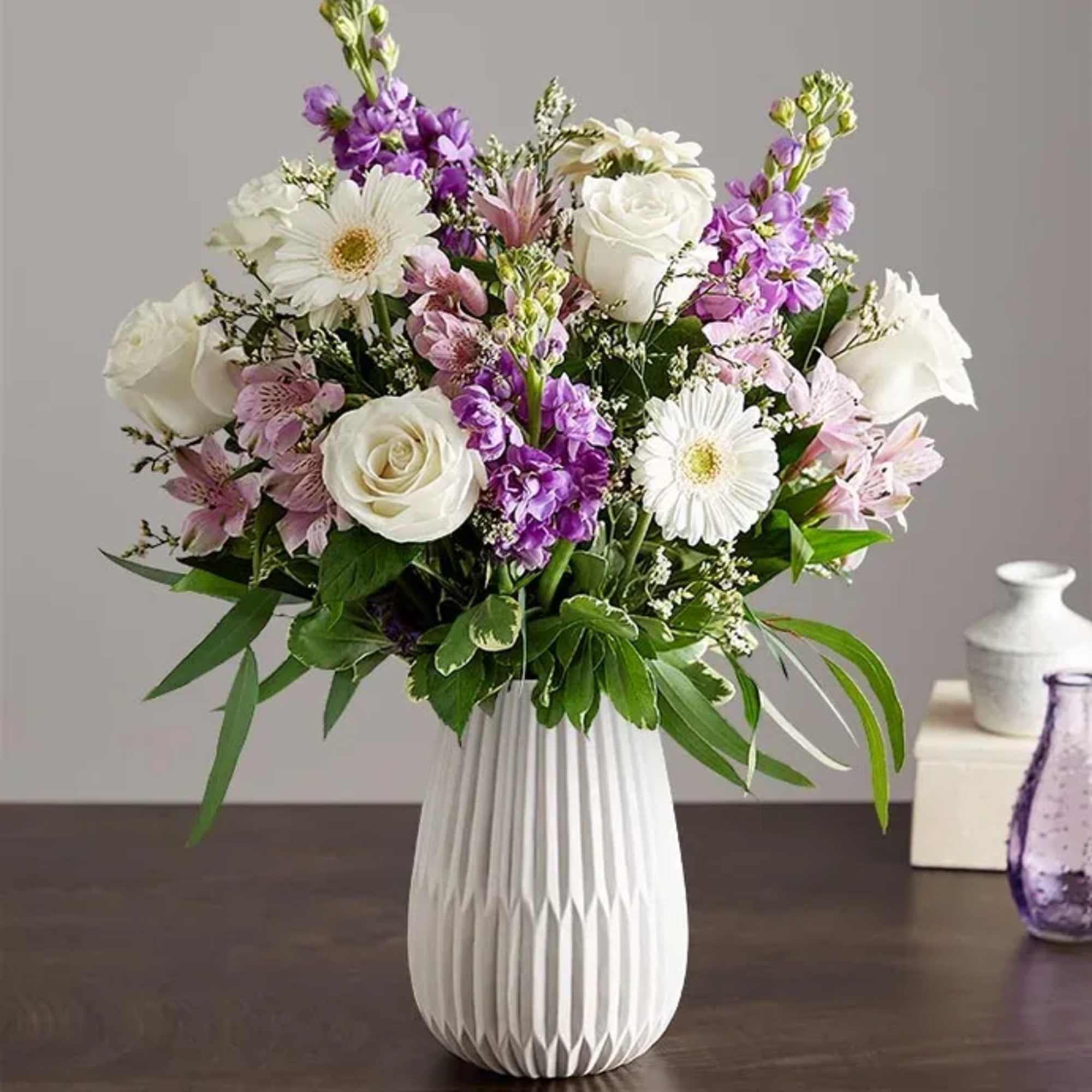 Soft lavender stock and crisp white roses mingle with lavender alstroemeria in