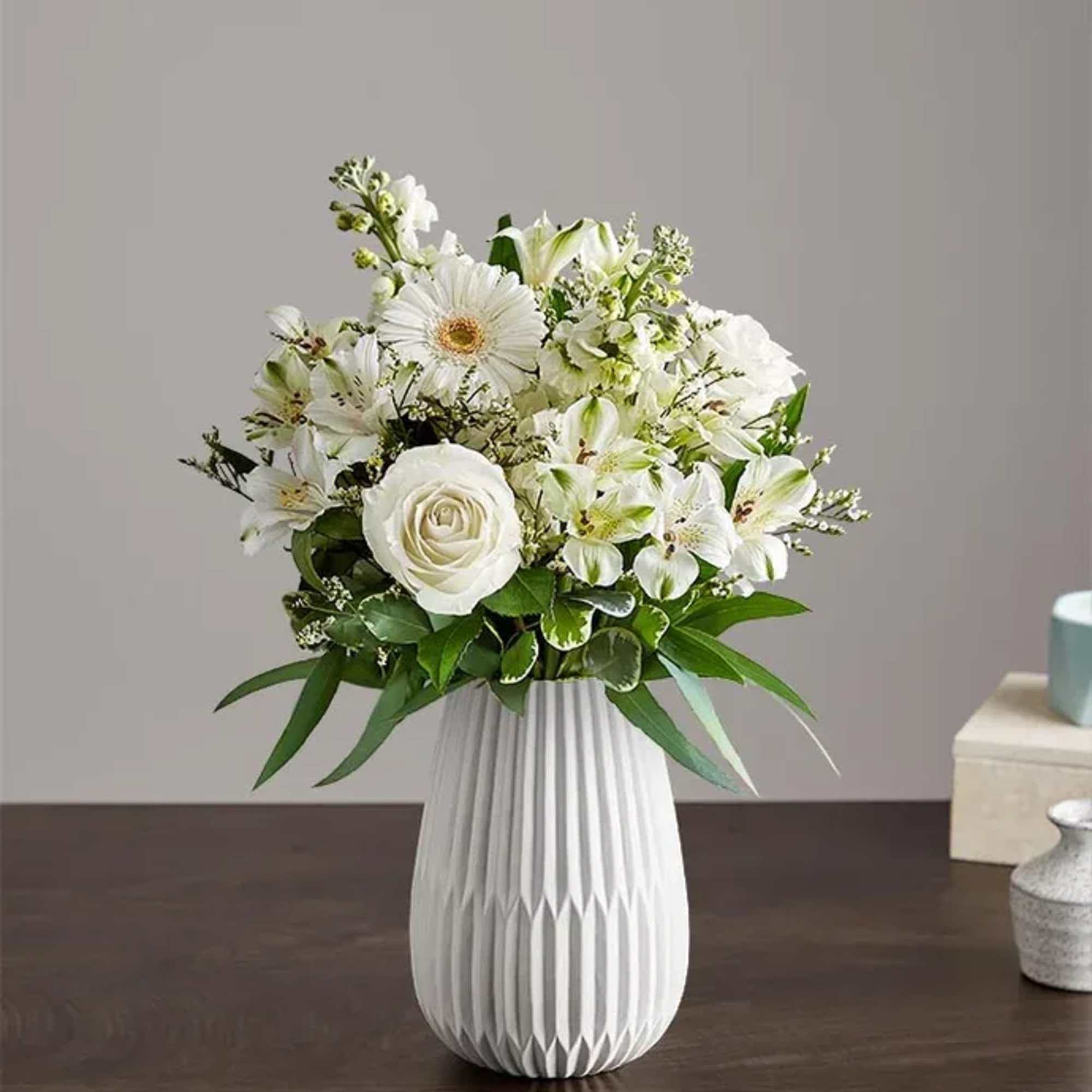 A serene all-white arrangement designed to comfort and celebrate-the ideal sympathy arrangement