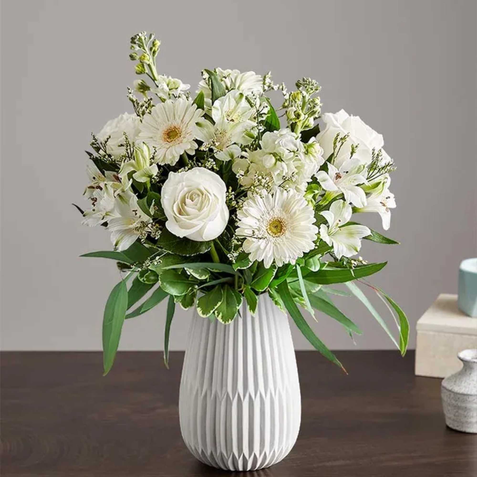 A serene all-white arrangement designed to comfort and celebrate-the ideal sympathy arrangement