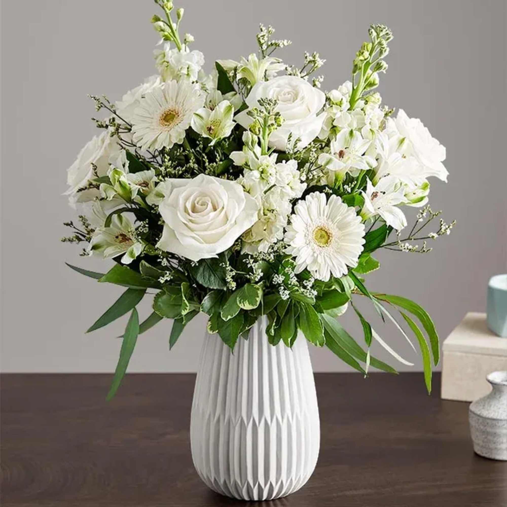 A serene all-white arrangement designed to comfort and celebrate-the ideal sympathy arrangement