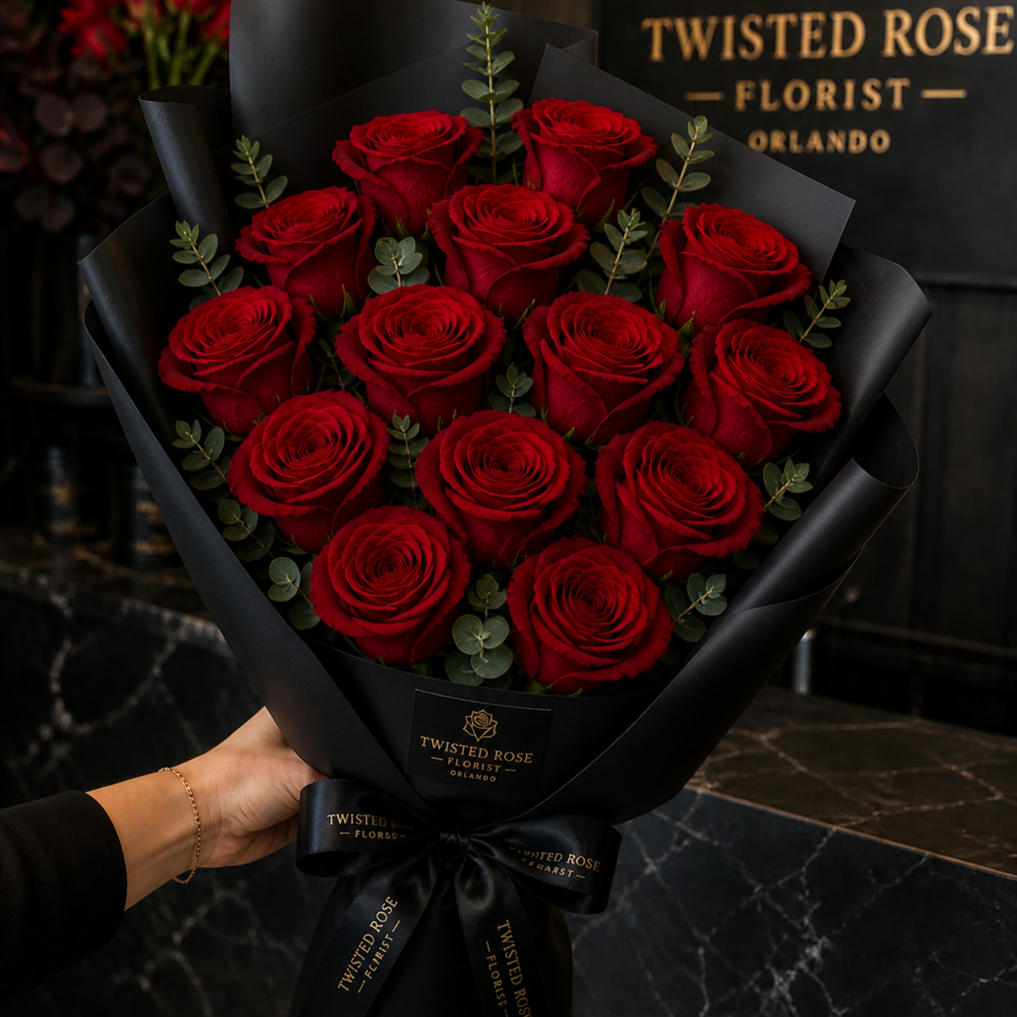 Three deep red roses set against matte black wrap create an instantly