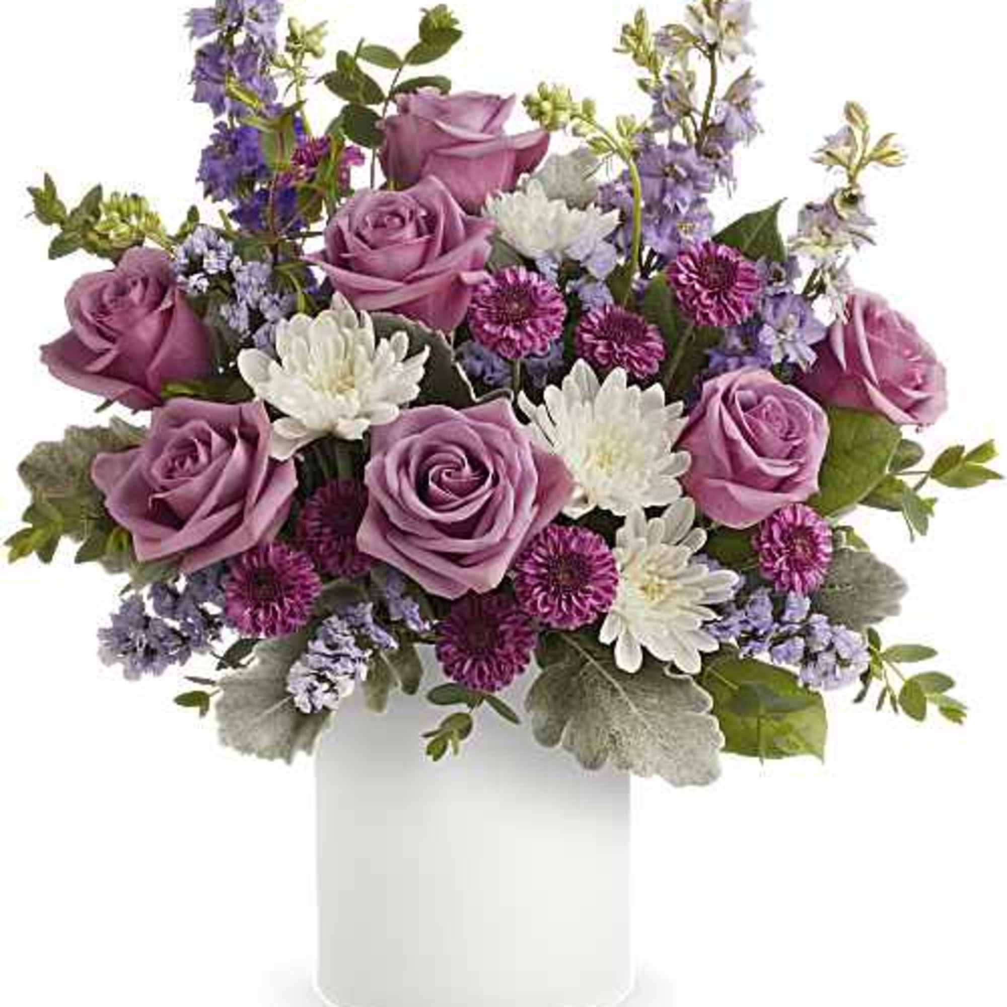 Lavender roses sit gently above white daisy-like blooms in a garden-style bouquet