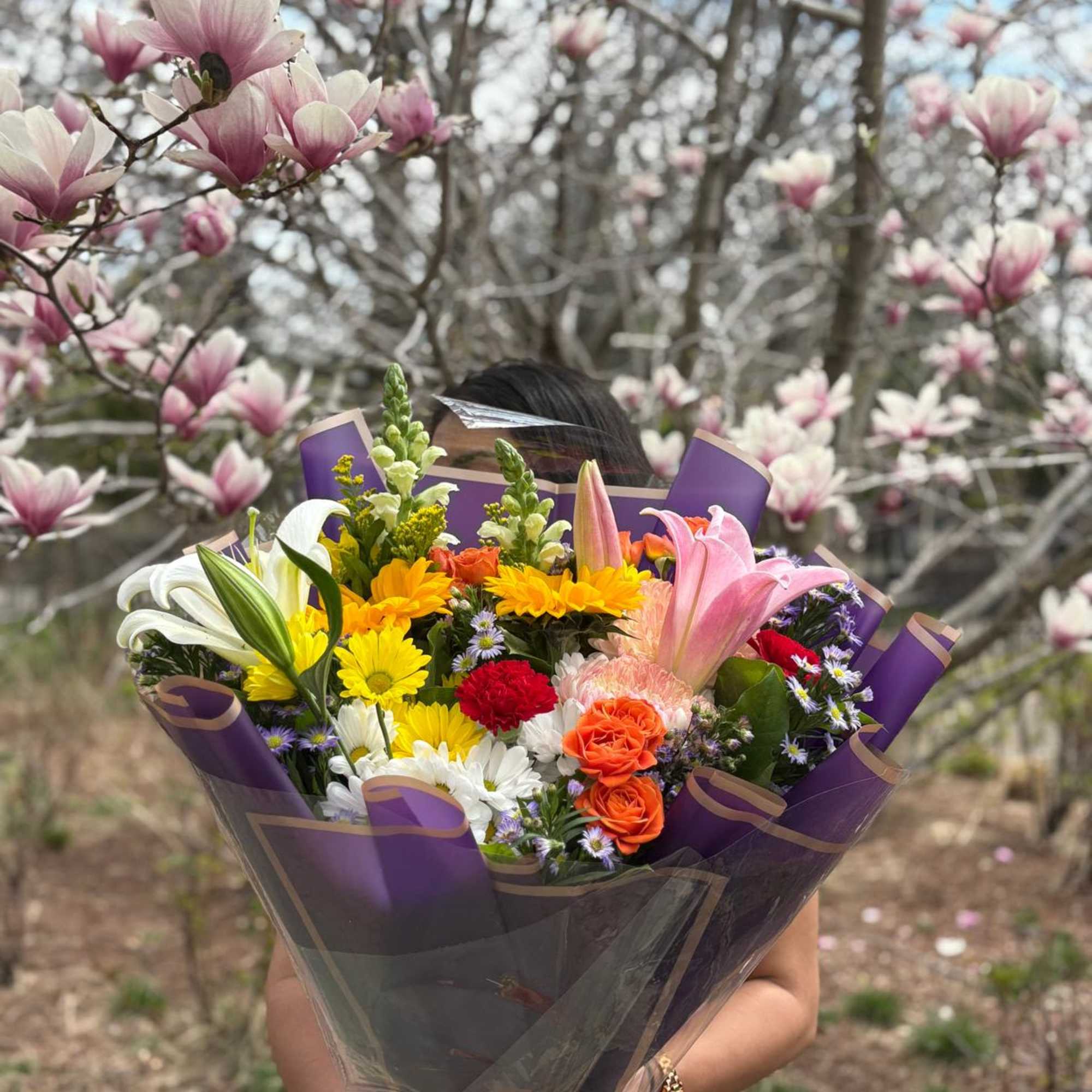 A cheerful bouquet with a mix of seasonal flowers. Designed, packaged, and