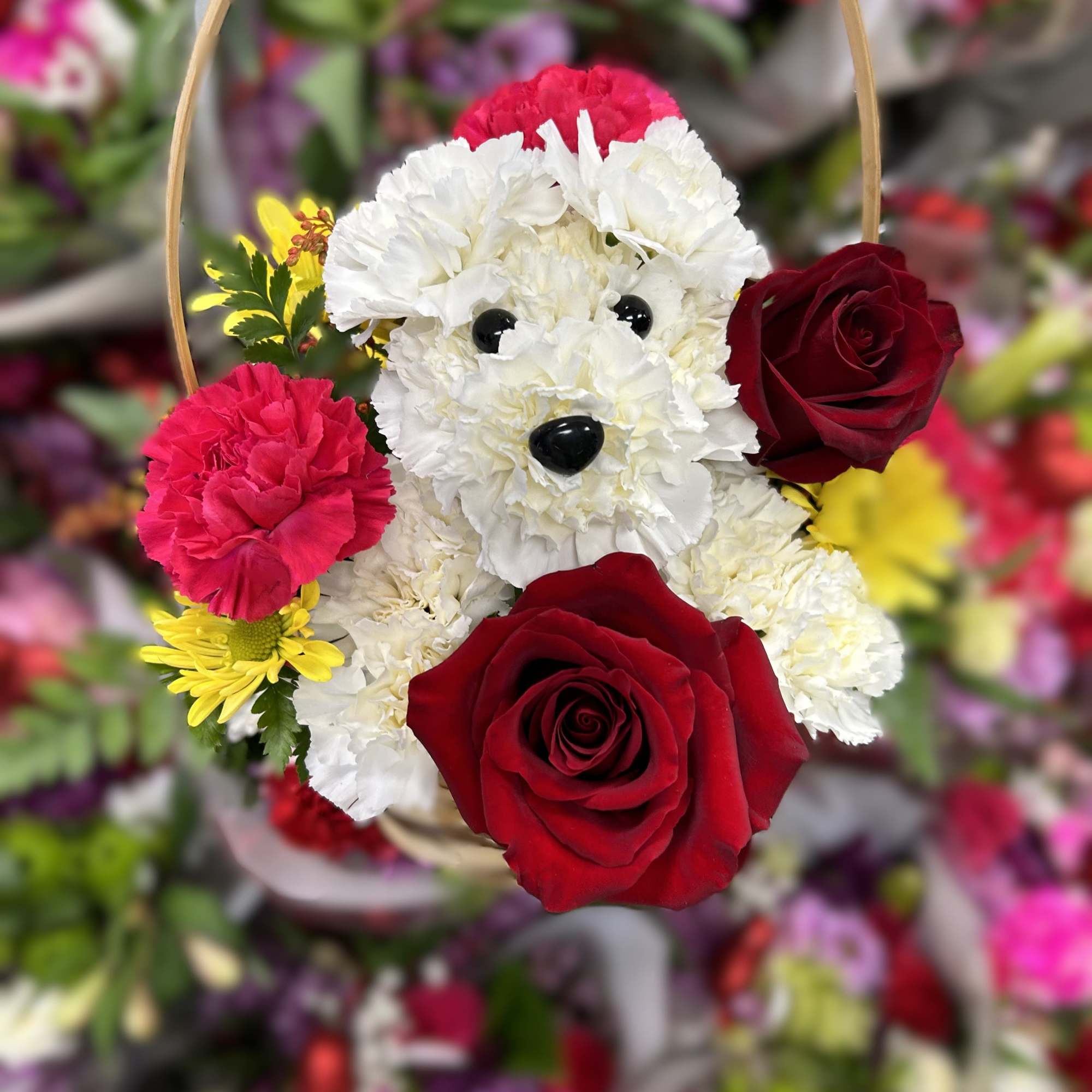 Flower basket shaped like a white dog with red roses and pink carnations
