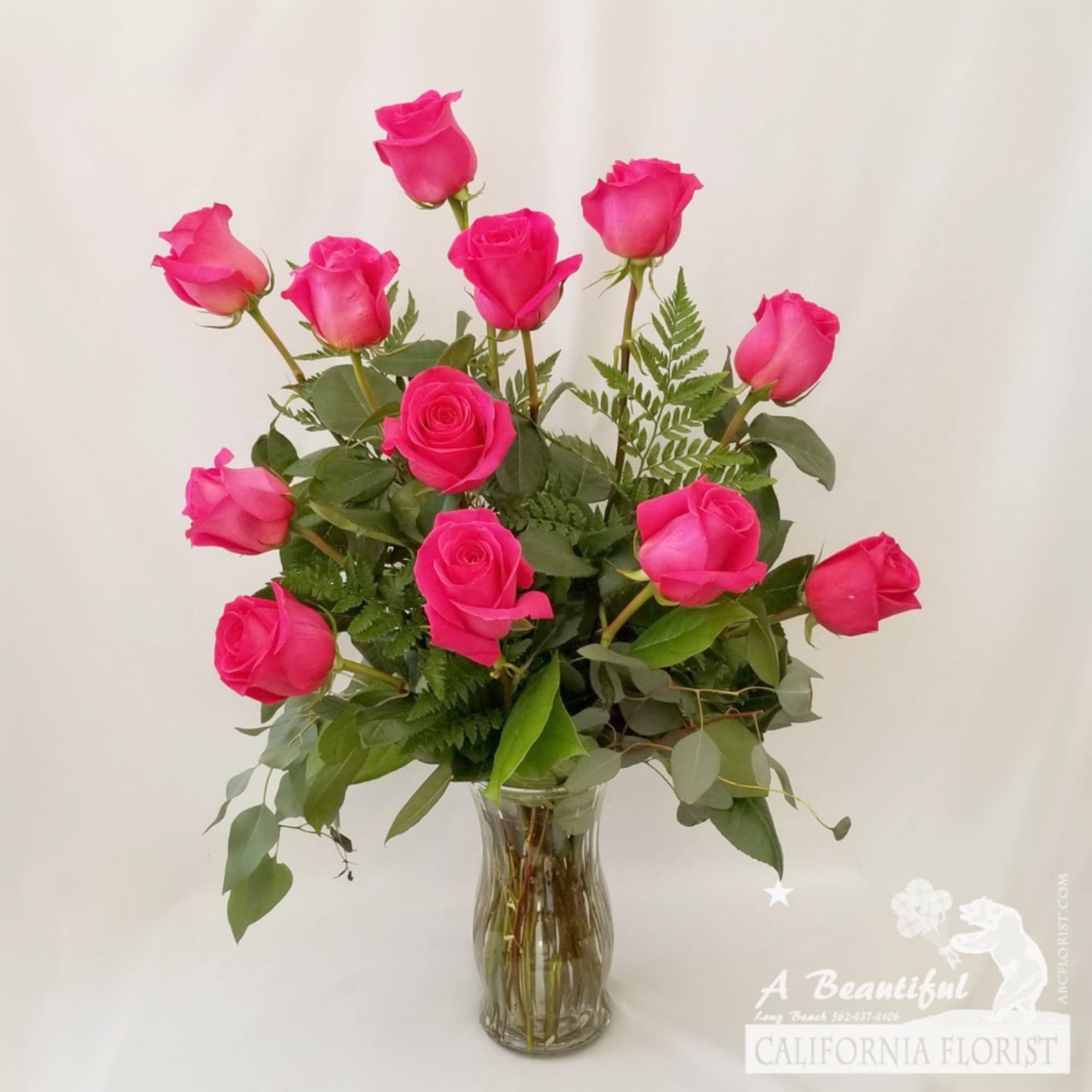 Beautiful arrangement of long stem PINK roses arranged in a vase and