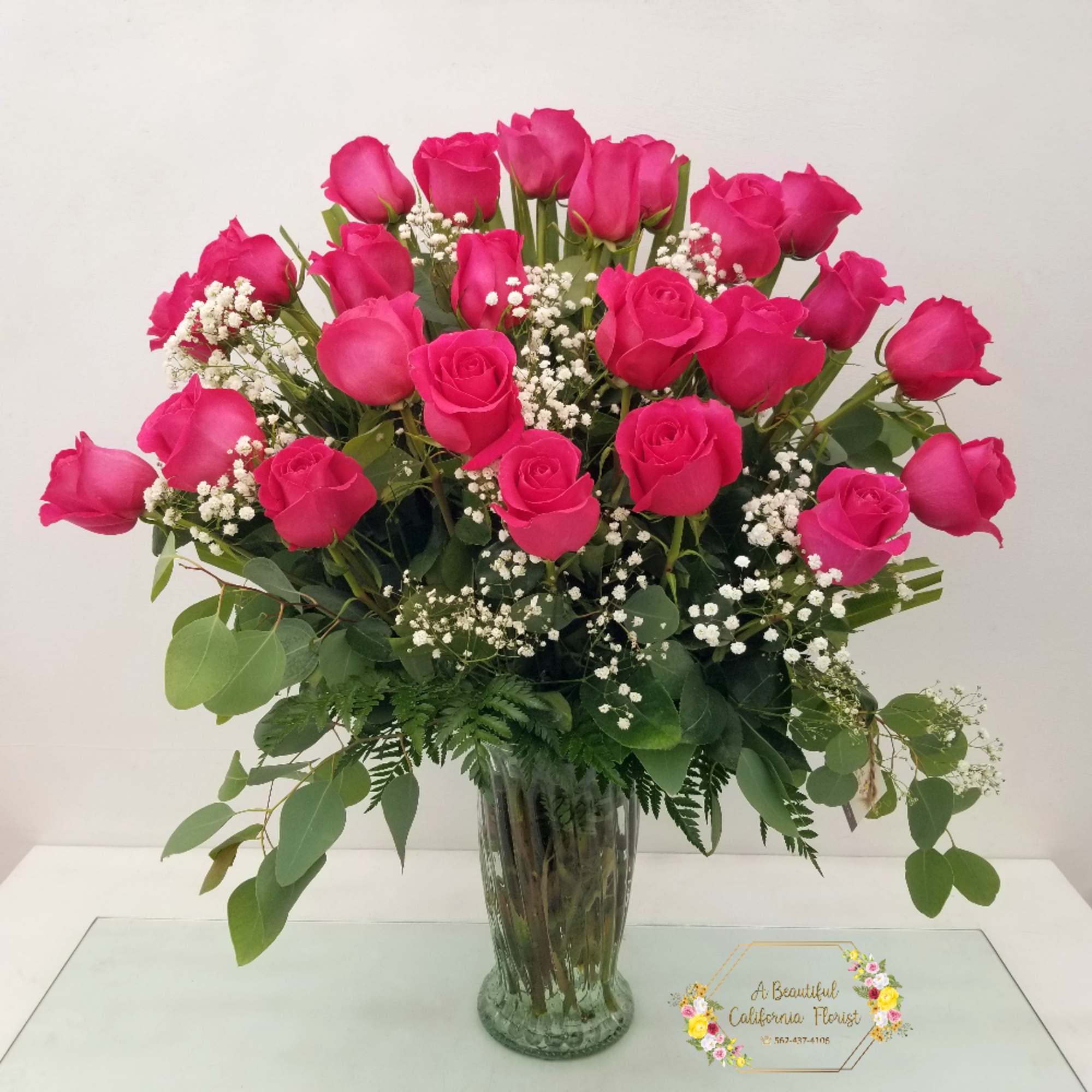 Beautiful arrangement of long stem PINK roses arranged in a vase and