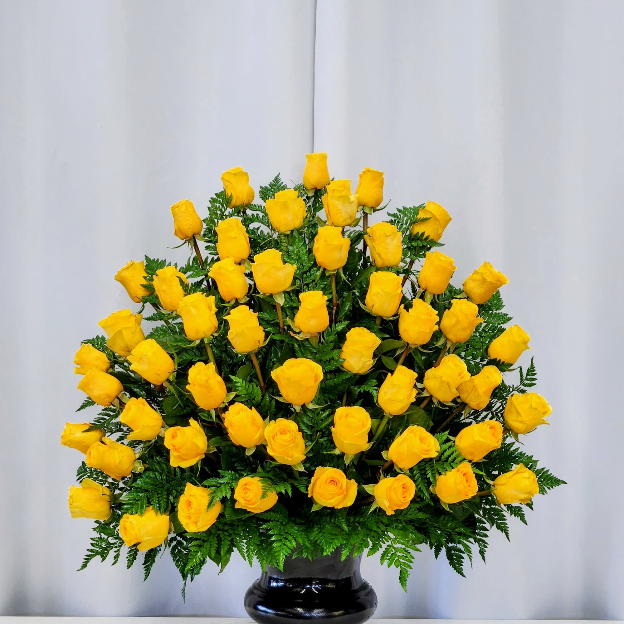 A glowing cluster of bright yellow roses creates immediate warmth-perfect as a