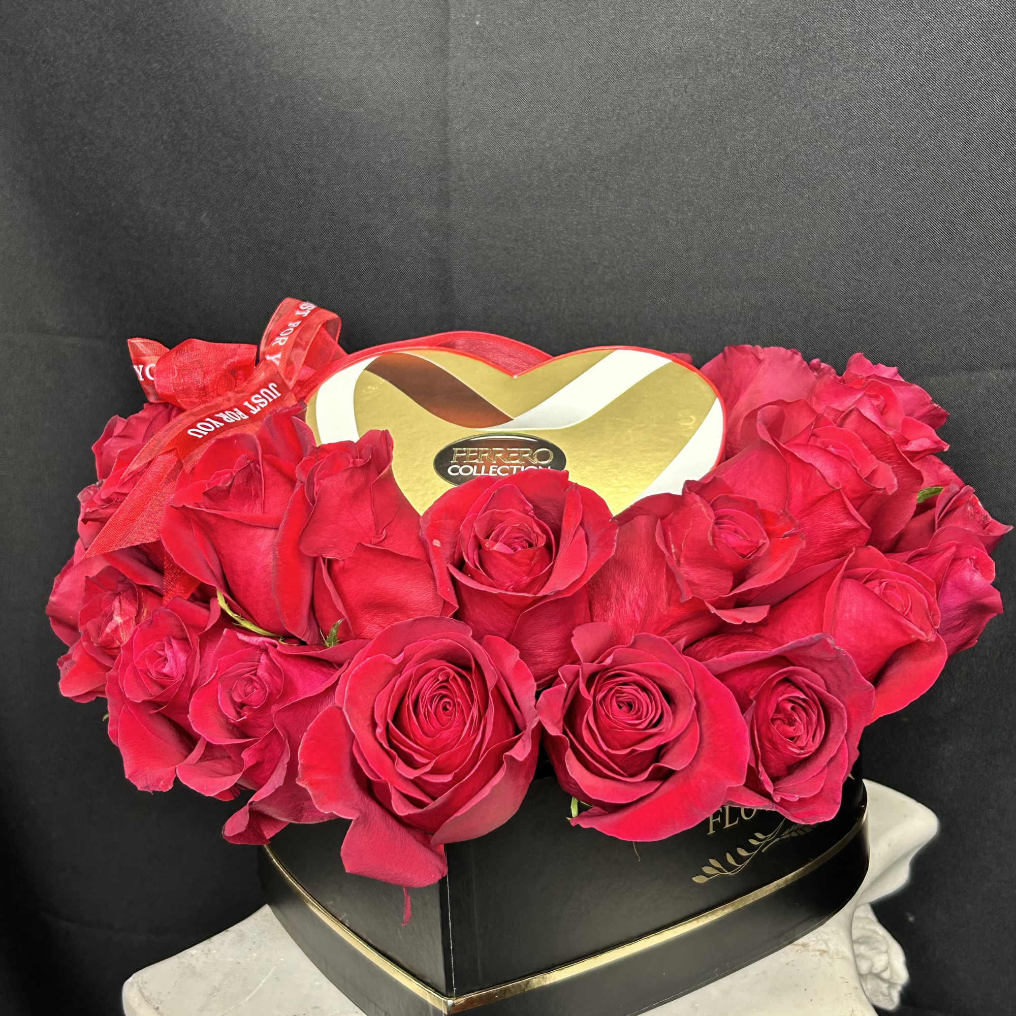 Heart-shaped box of red roses with a Ferrero Rocher gift box on top