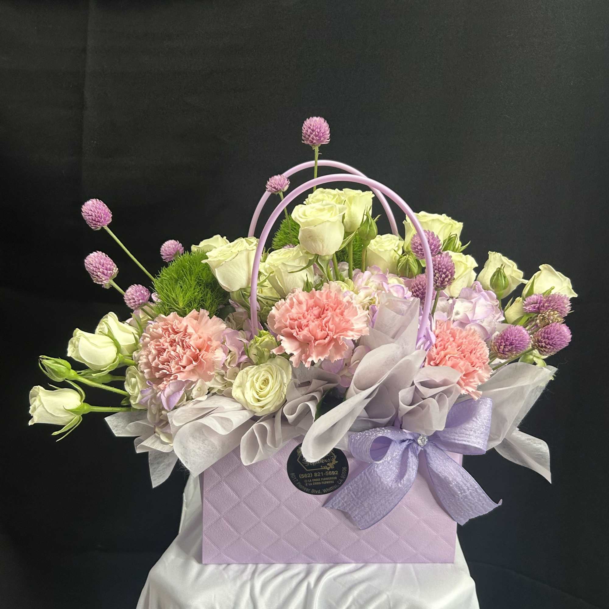 Lavender gift box with pastel roses, carnations, and purple accents