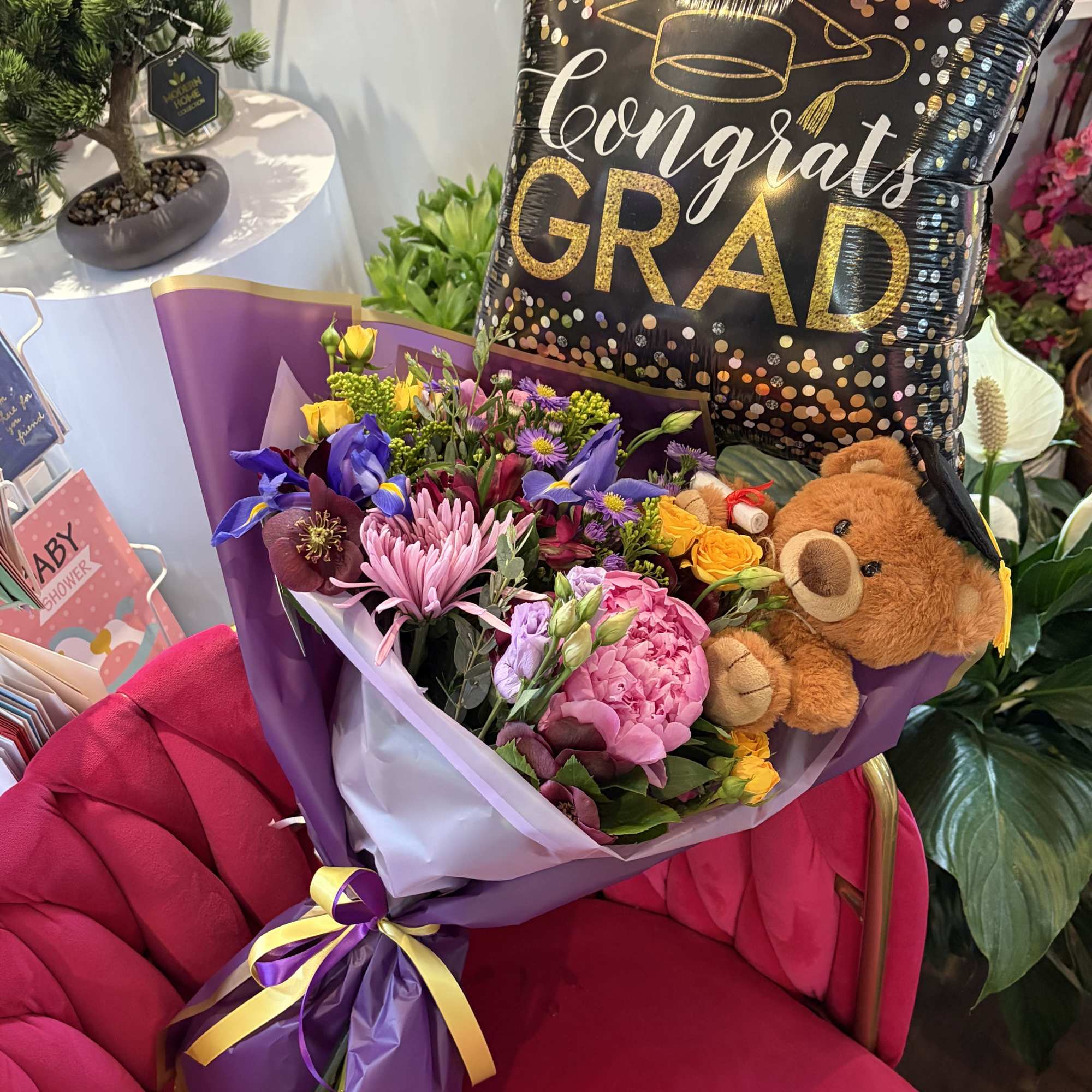 Bursting with jubilant color and celebratory flair, this graduation flower arrangement is