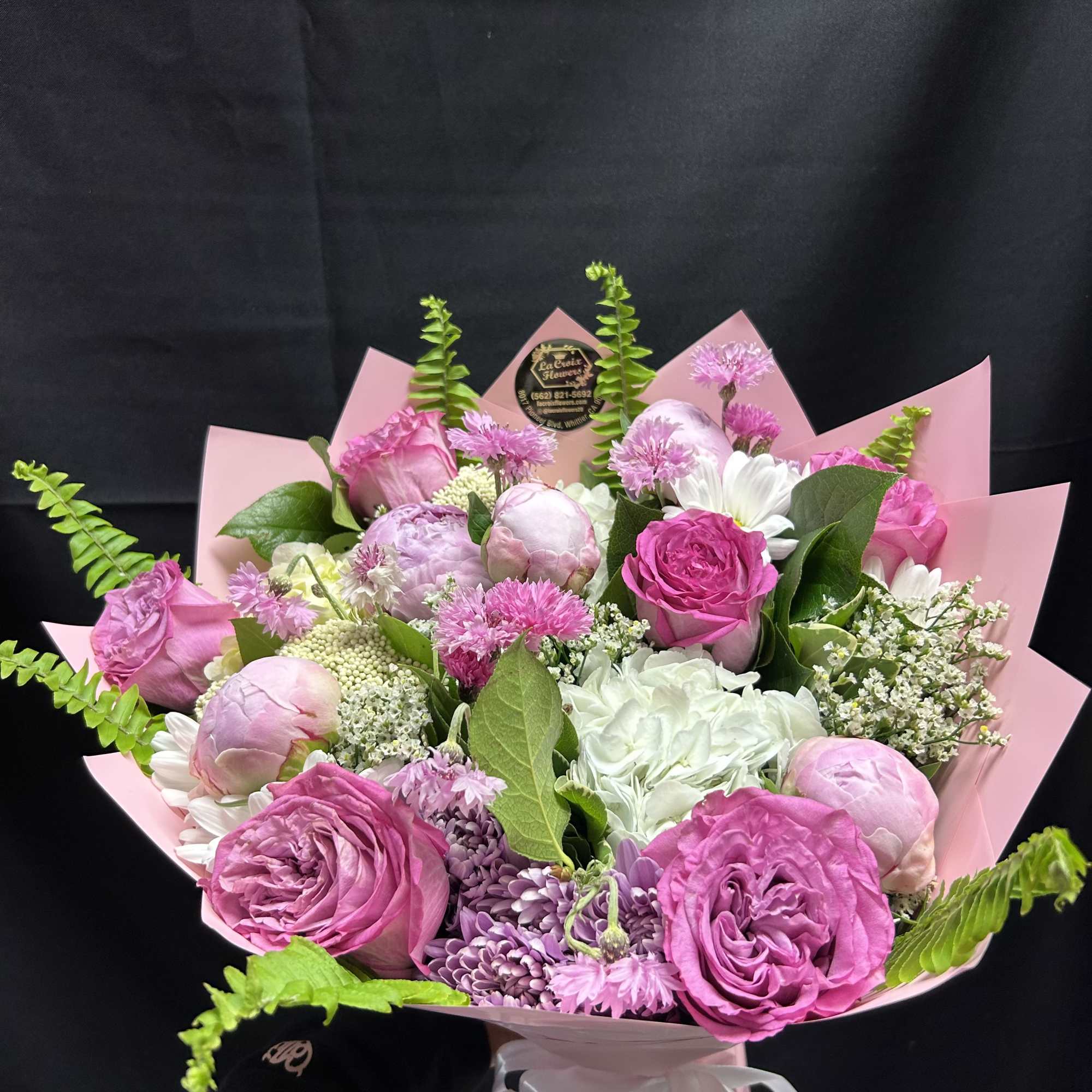 Soft blush peonies and bright pink roses steal the show in this