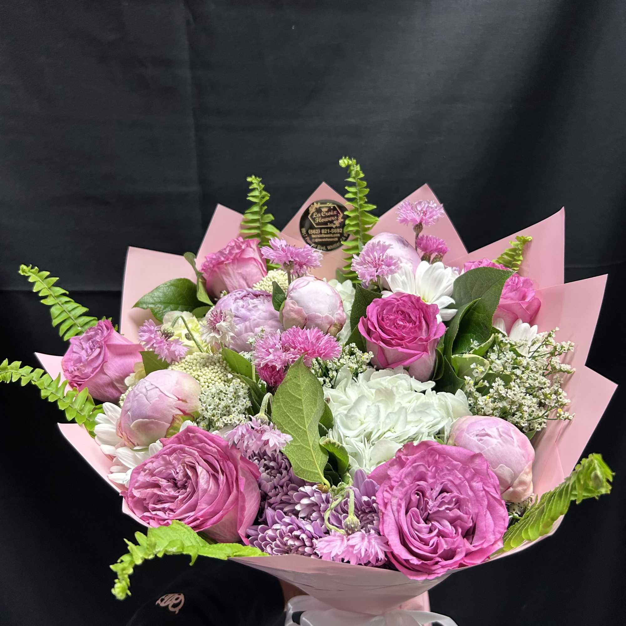 Soft blush peonies and bright pink roses steal the show in this