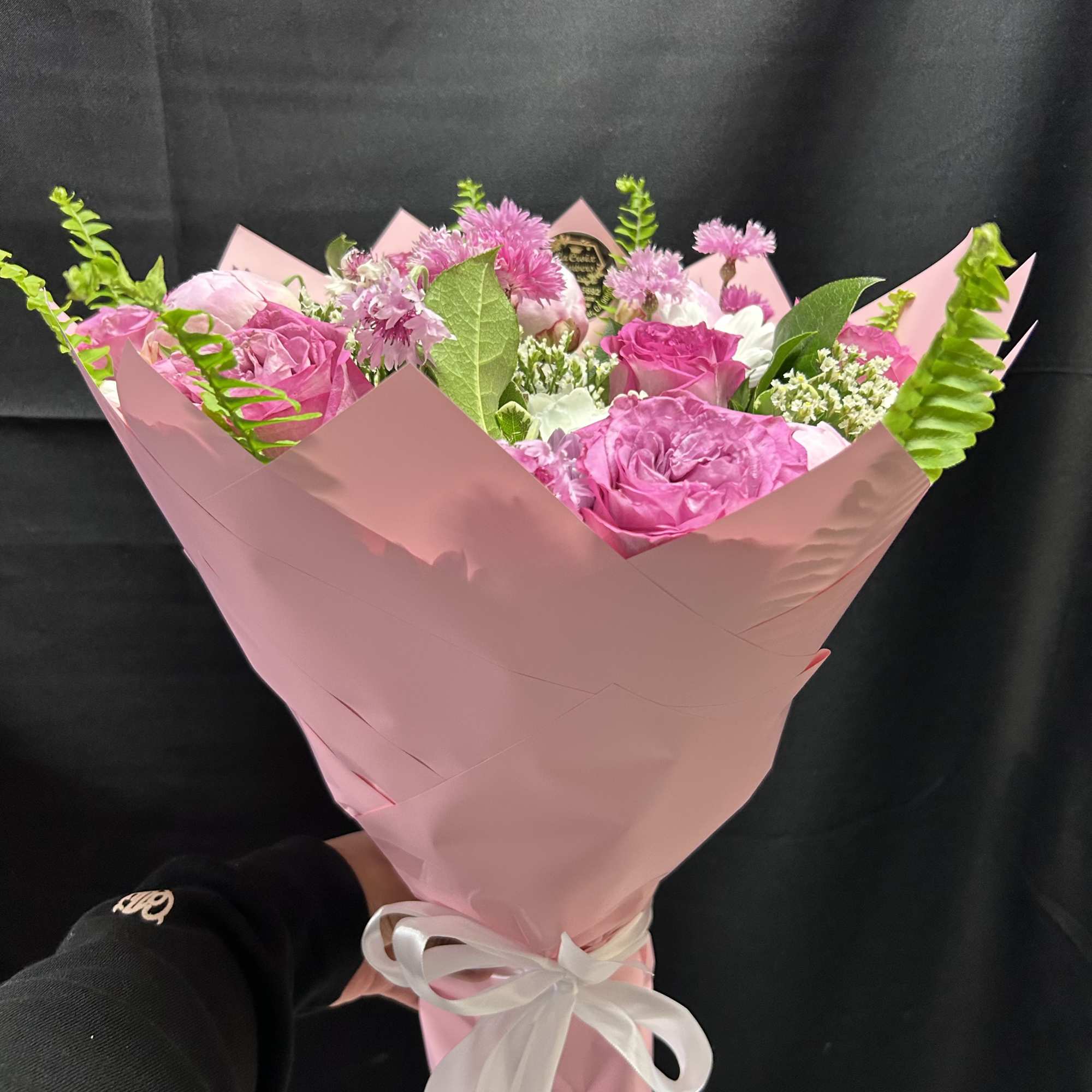 Soft blush peonies and bright pink roses steal the show in this