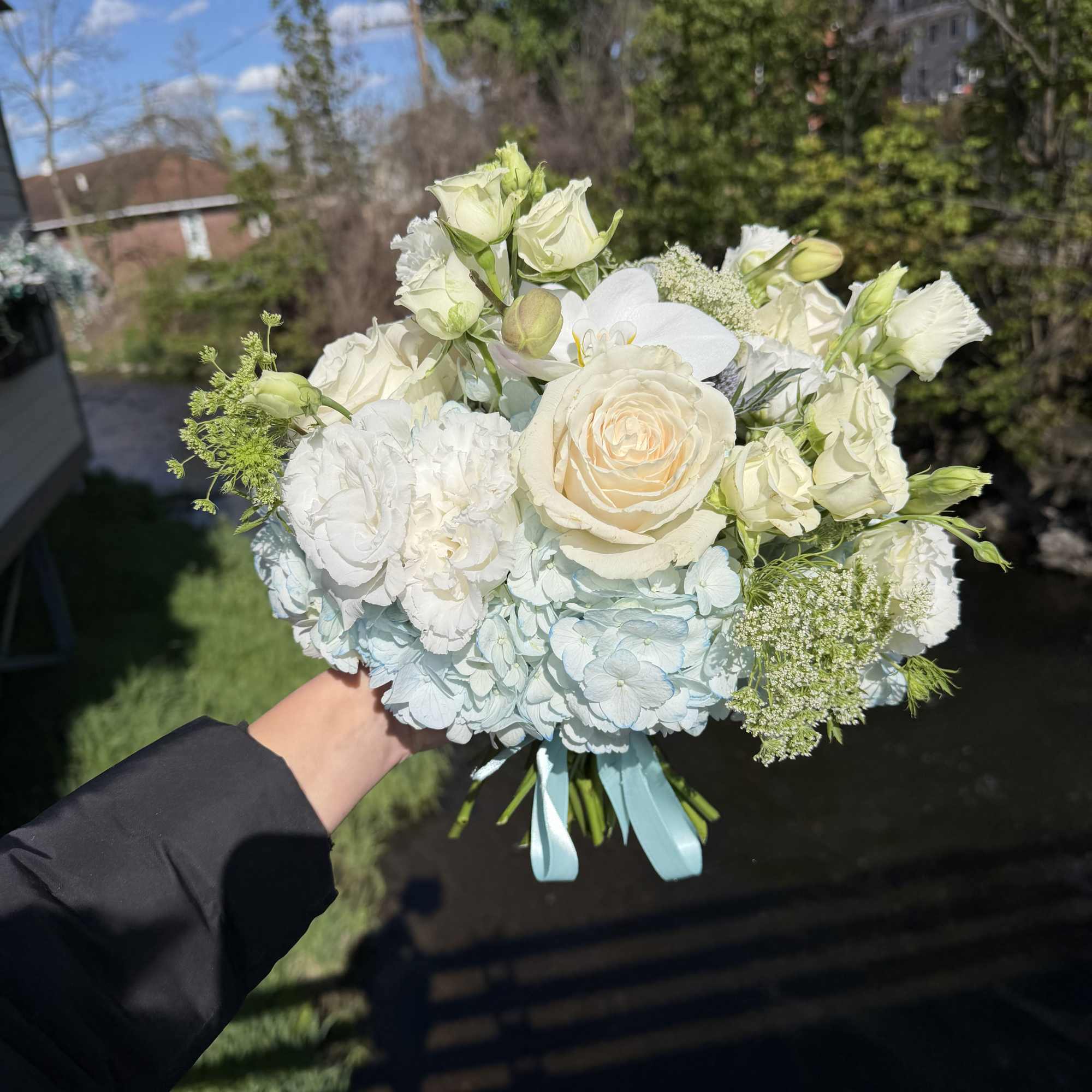 A delicate hand-tied prom bouquet designed to complement a formal gown and