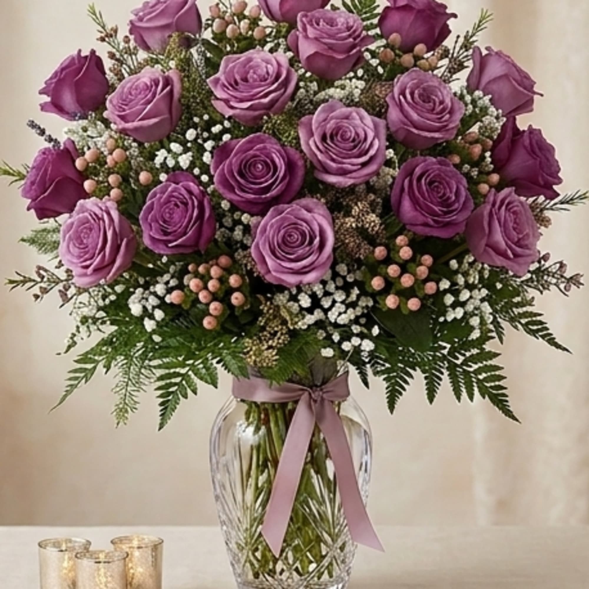 PURPLE/LAVENDER ROSES ARRANGED IN A VASE, WITH GREENS AND FILLERS, IF YOU