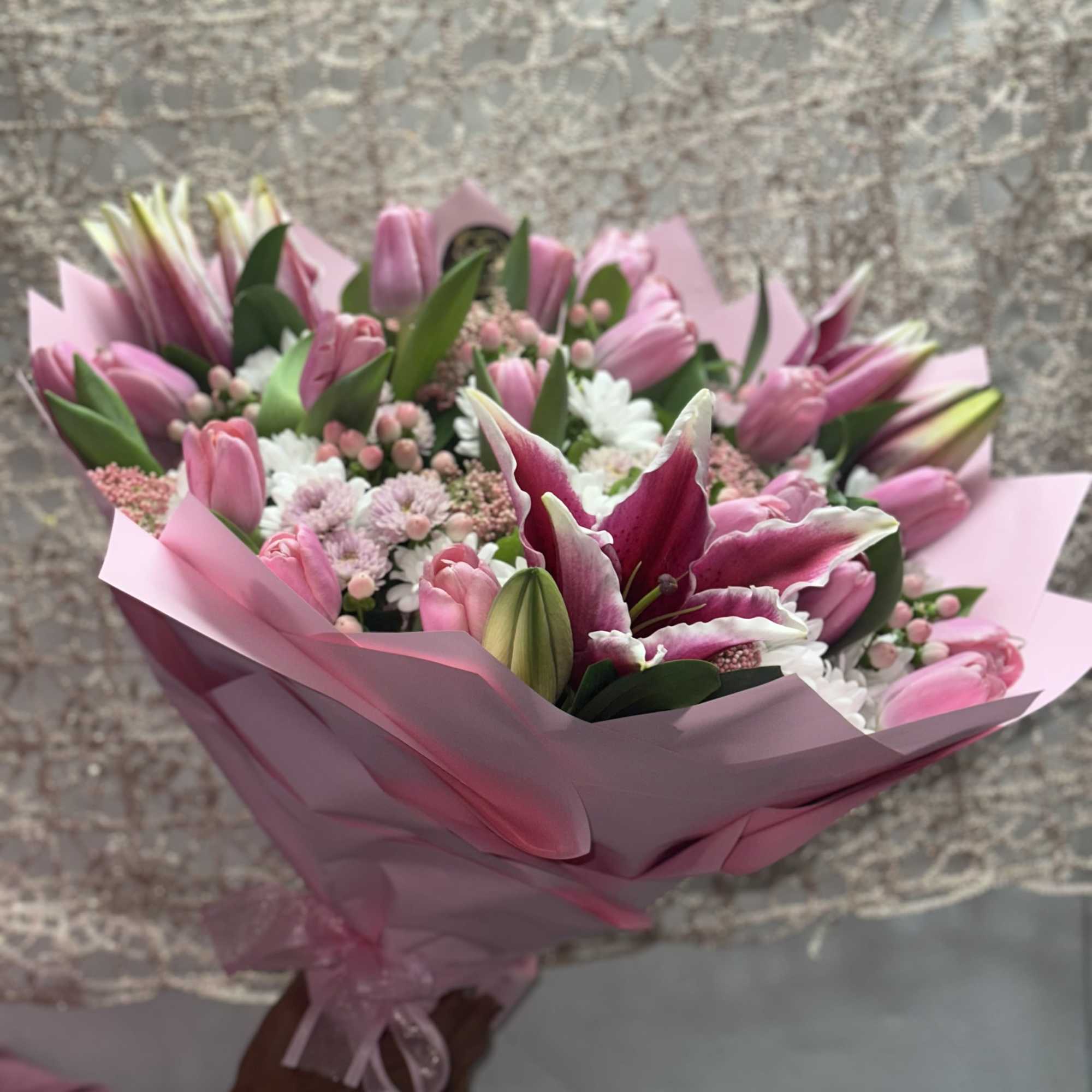 Pink bouquet with lilies and tulips wrapped in pink paper
