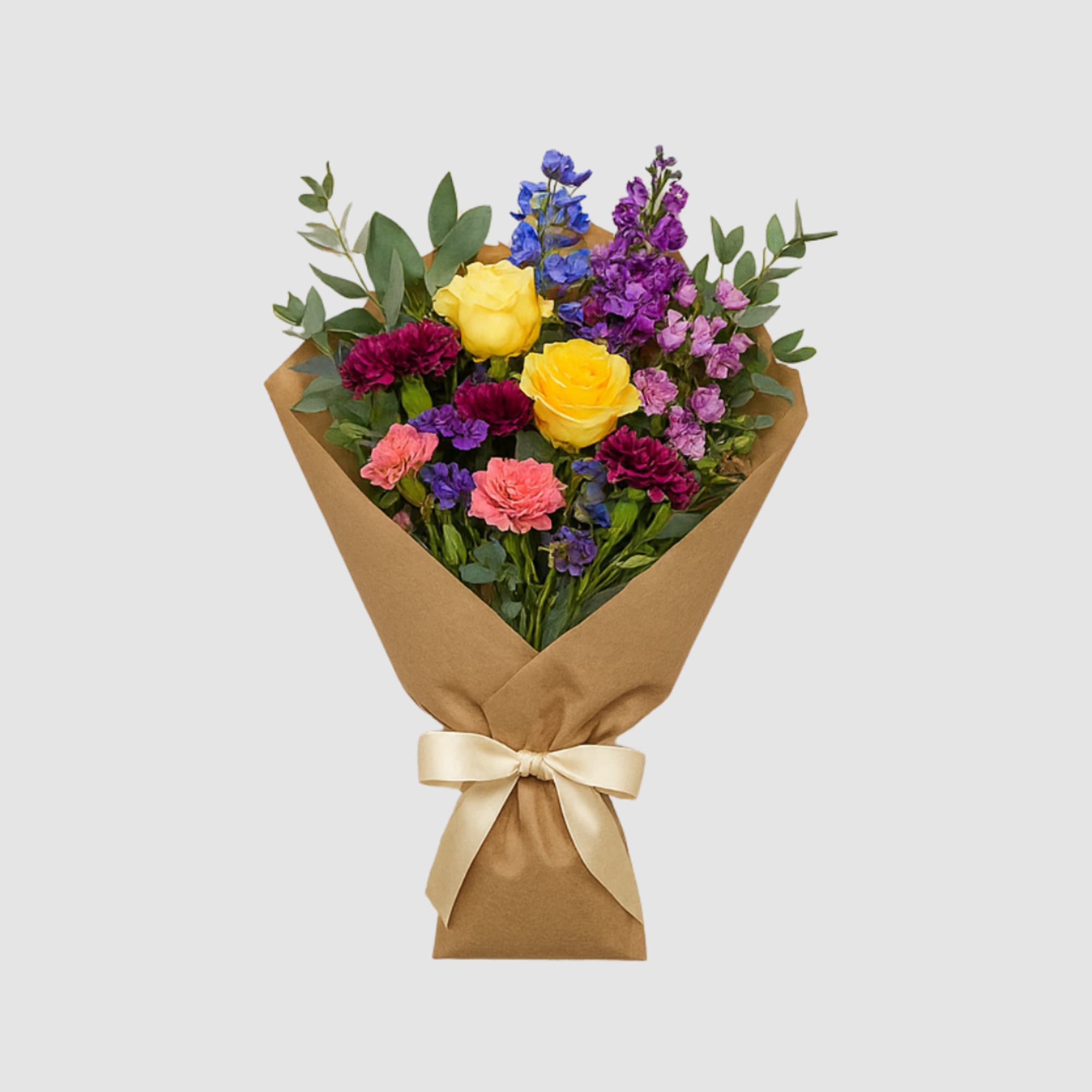 Mixed bouquet of yellow roses, purple flowers, and pink carnations wrapped in brown paper