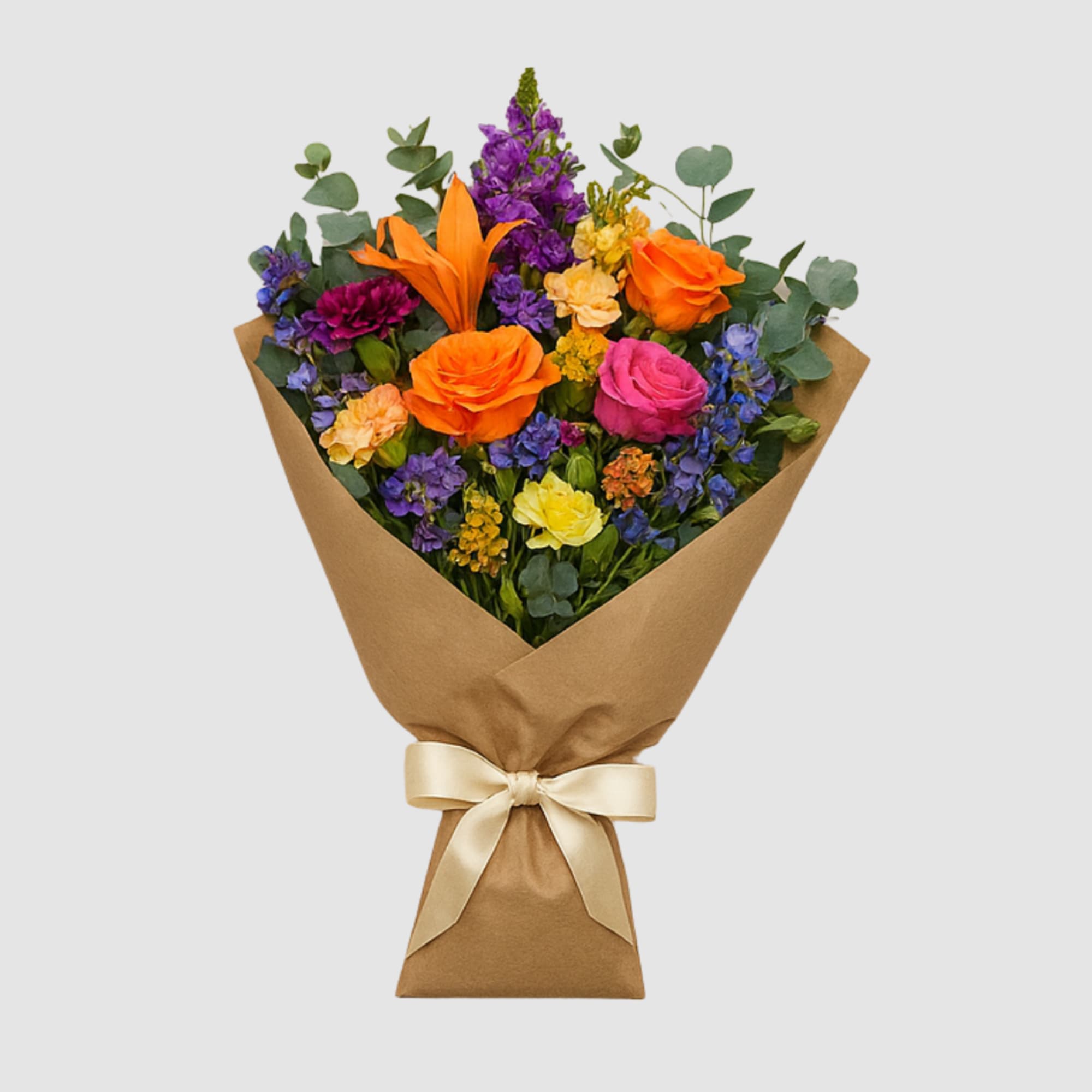 Mixed bouquet of bright flowers wrapped in brown paper with a satin ribbon