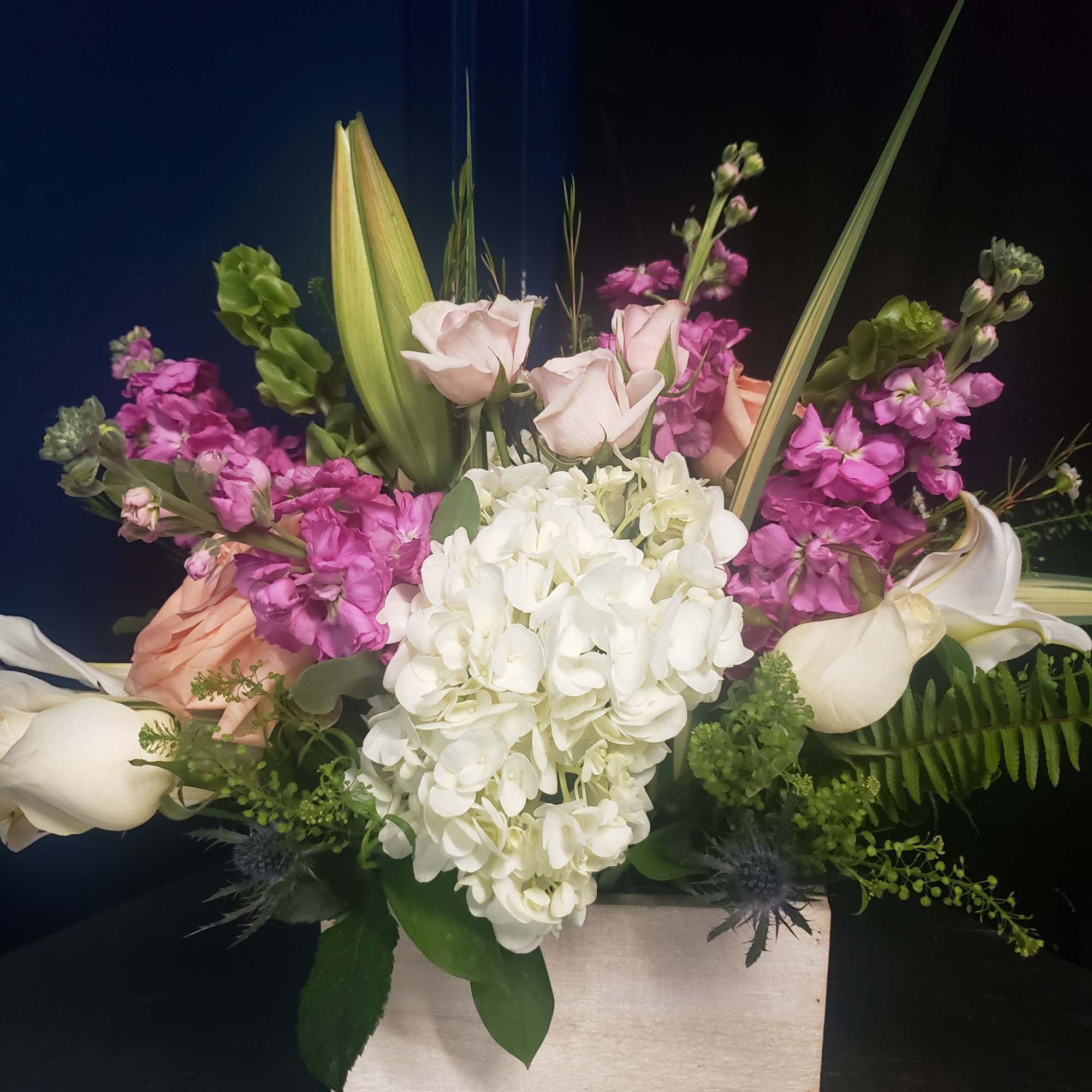 A lush cluster of creamy white hydrangea anchors this Mother's Day flower