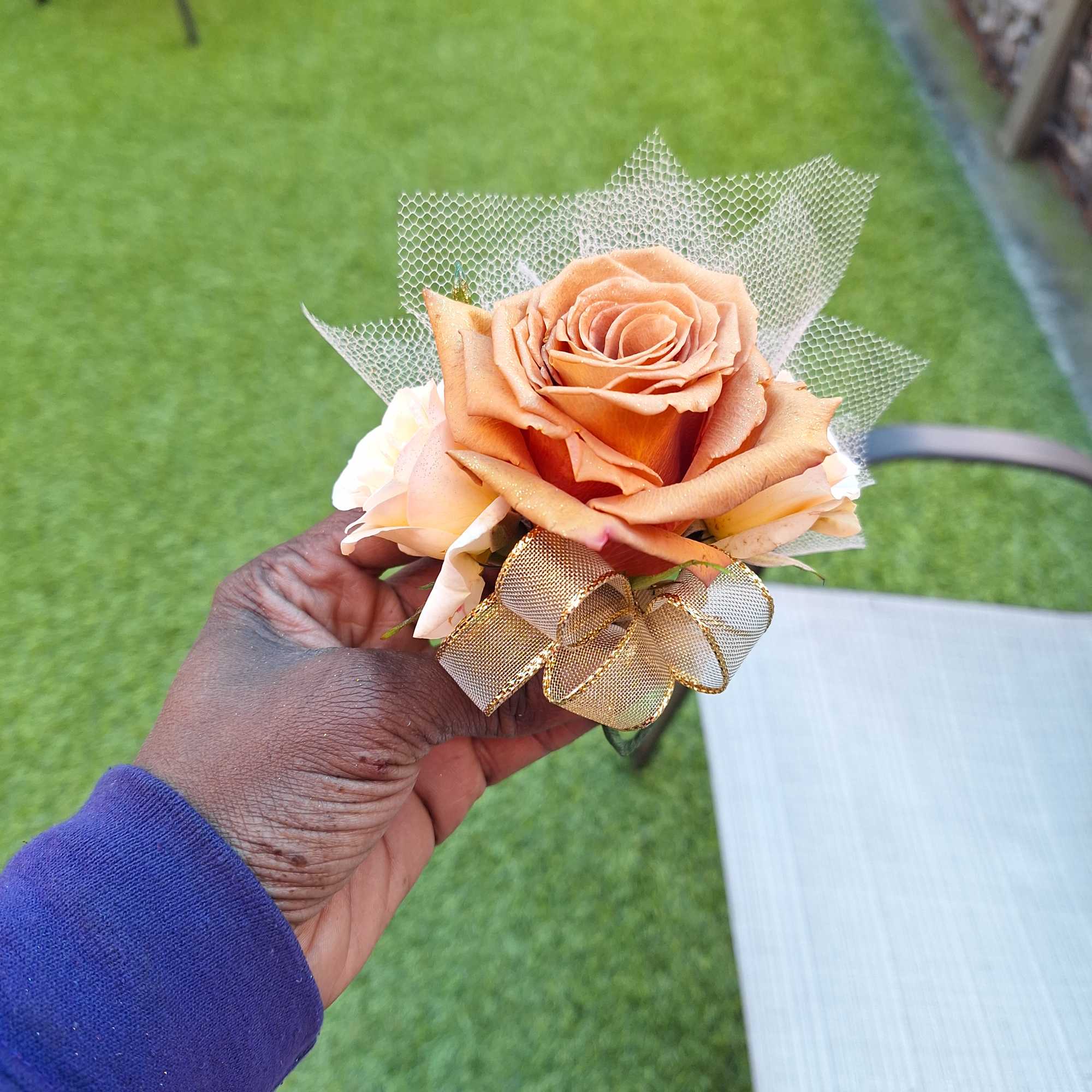 Small peach rose bouquet with gold ribbon and mesh wrap
