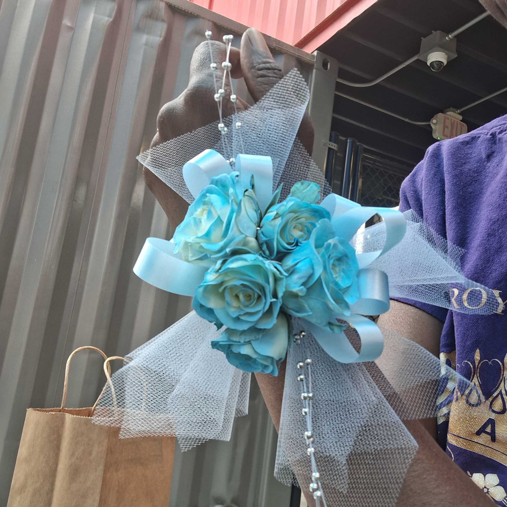 Blue rose corsage with white tulle and ribbon