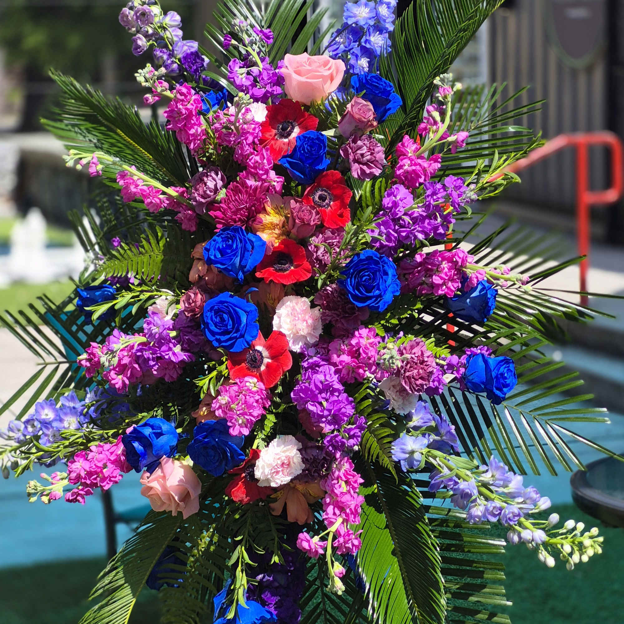 A splendid display of blue and Lavender roses, blue and purple Delphinium