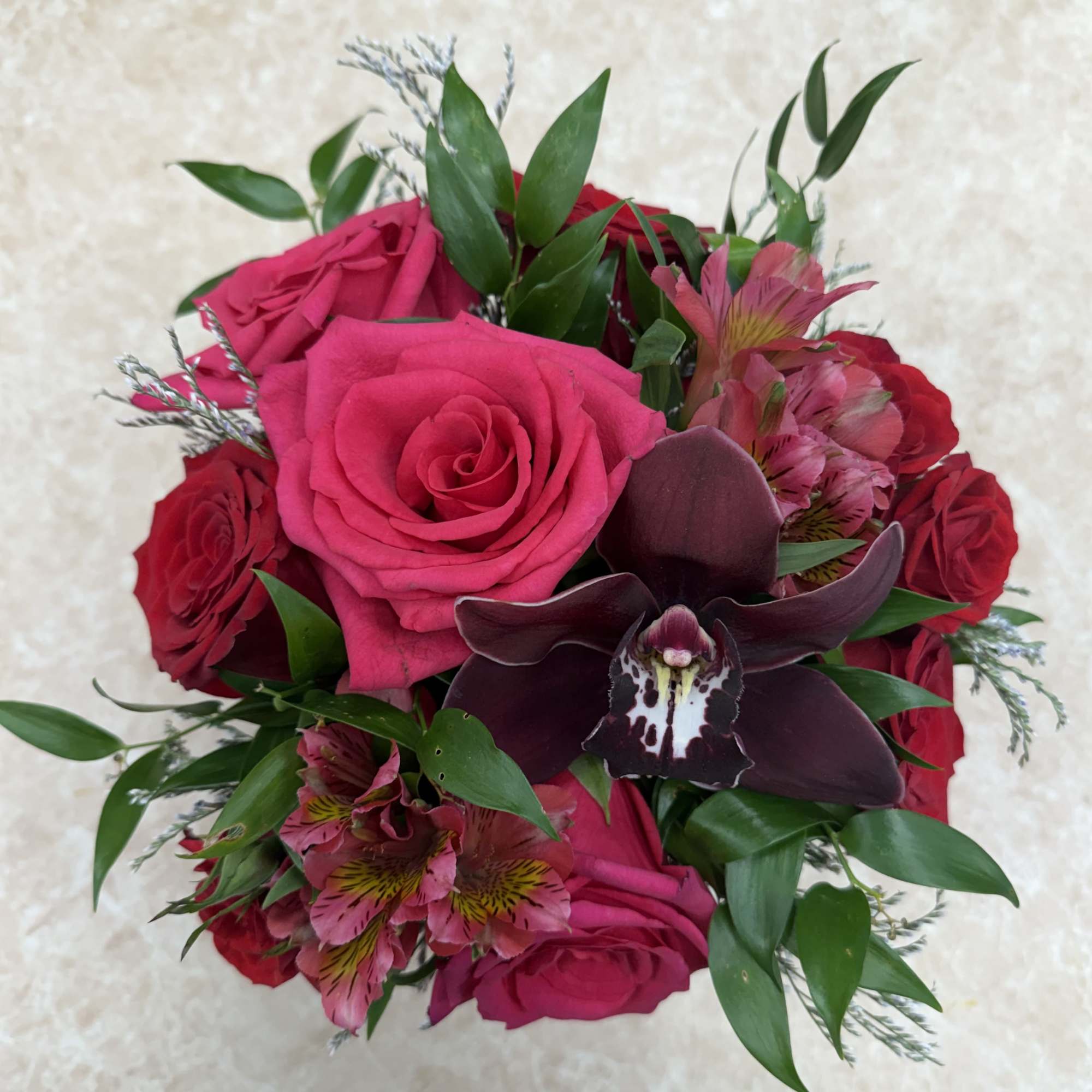 Bouquet of hot pink roses with a dark orchid and pink alstroemeria