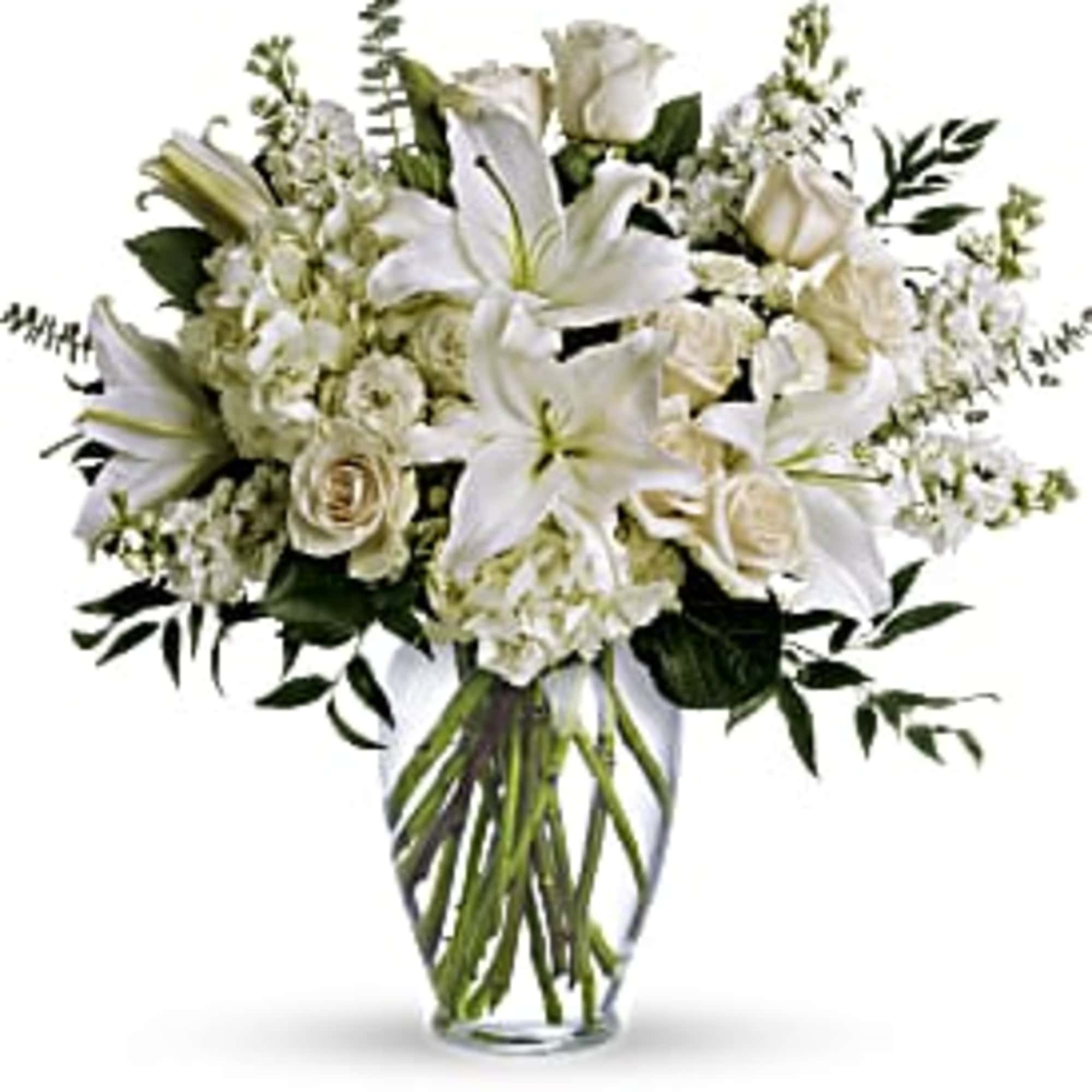 White lilies and roses arranged in a clear glass vase