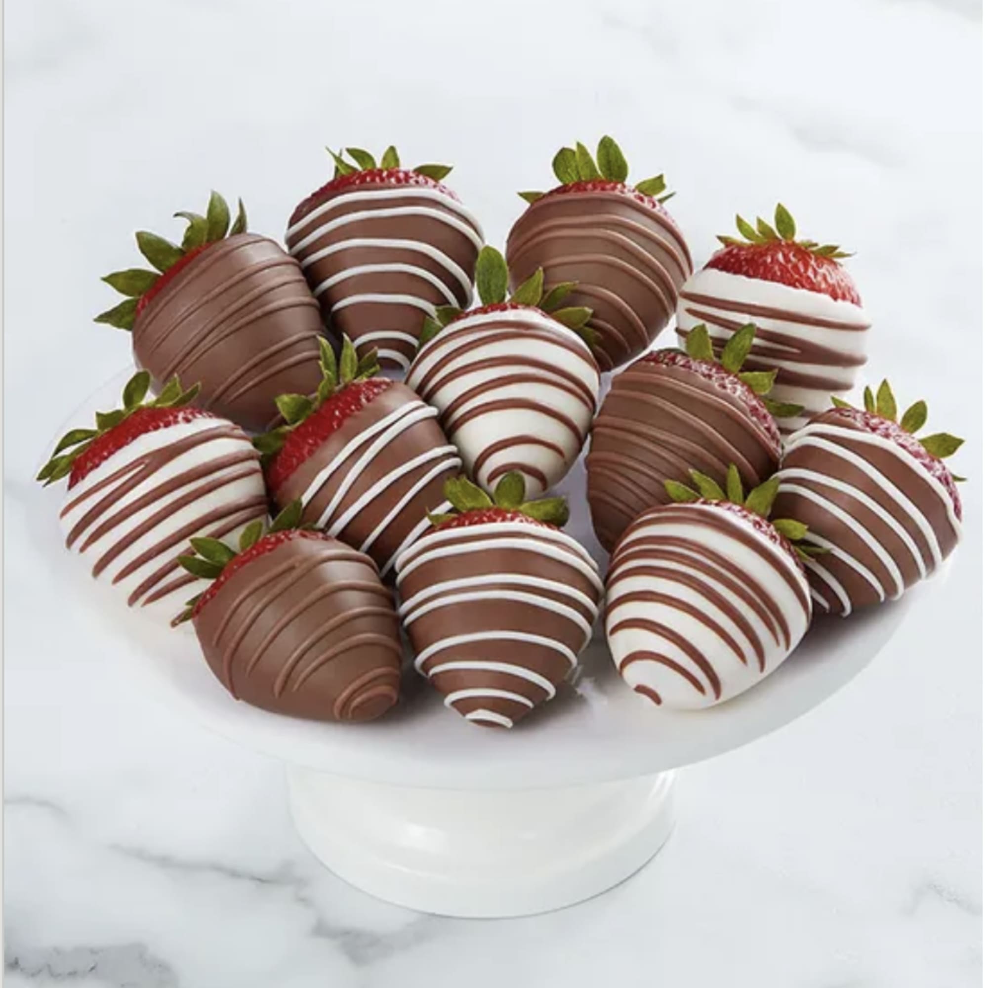 Chocolate-covered strawberries arranged on a white pedestal stand