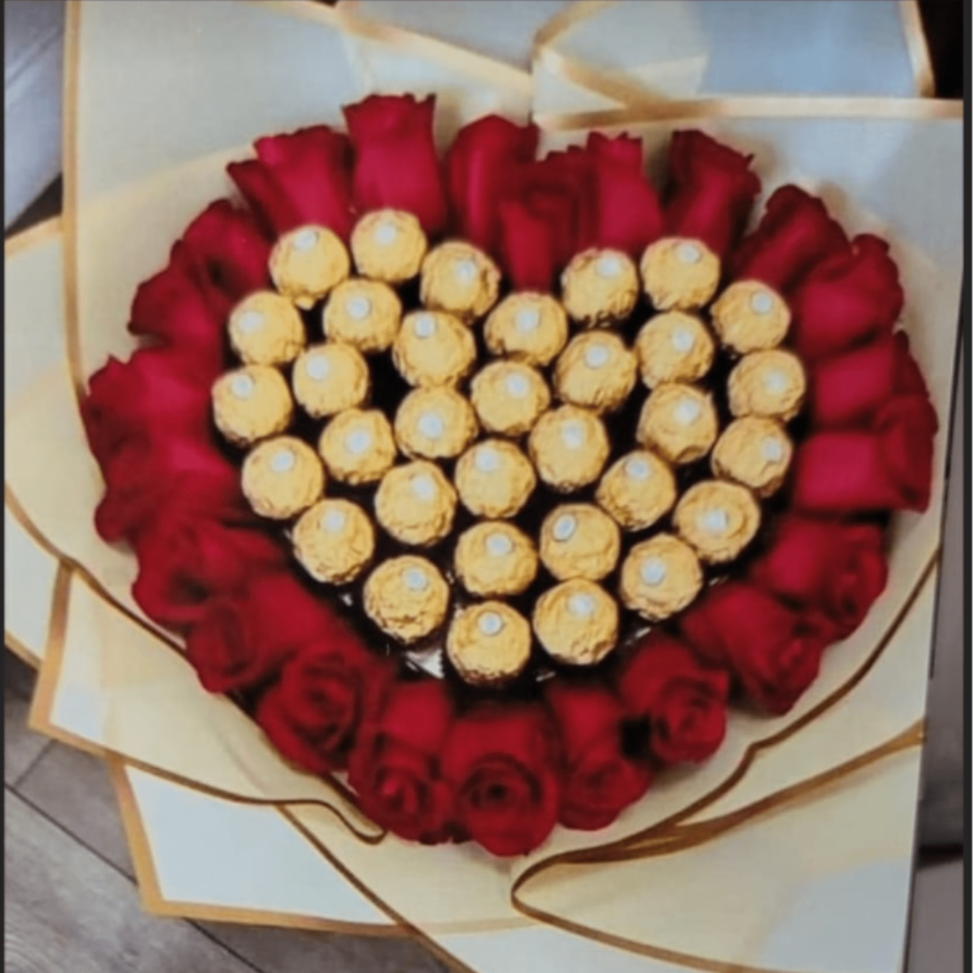 A heart-shaped cluster of deep red roses ringed around a glittering center