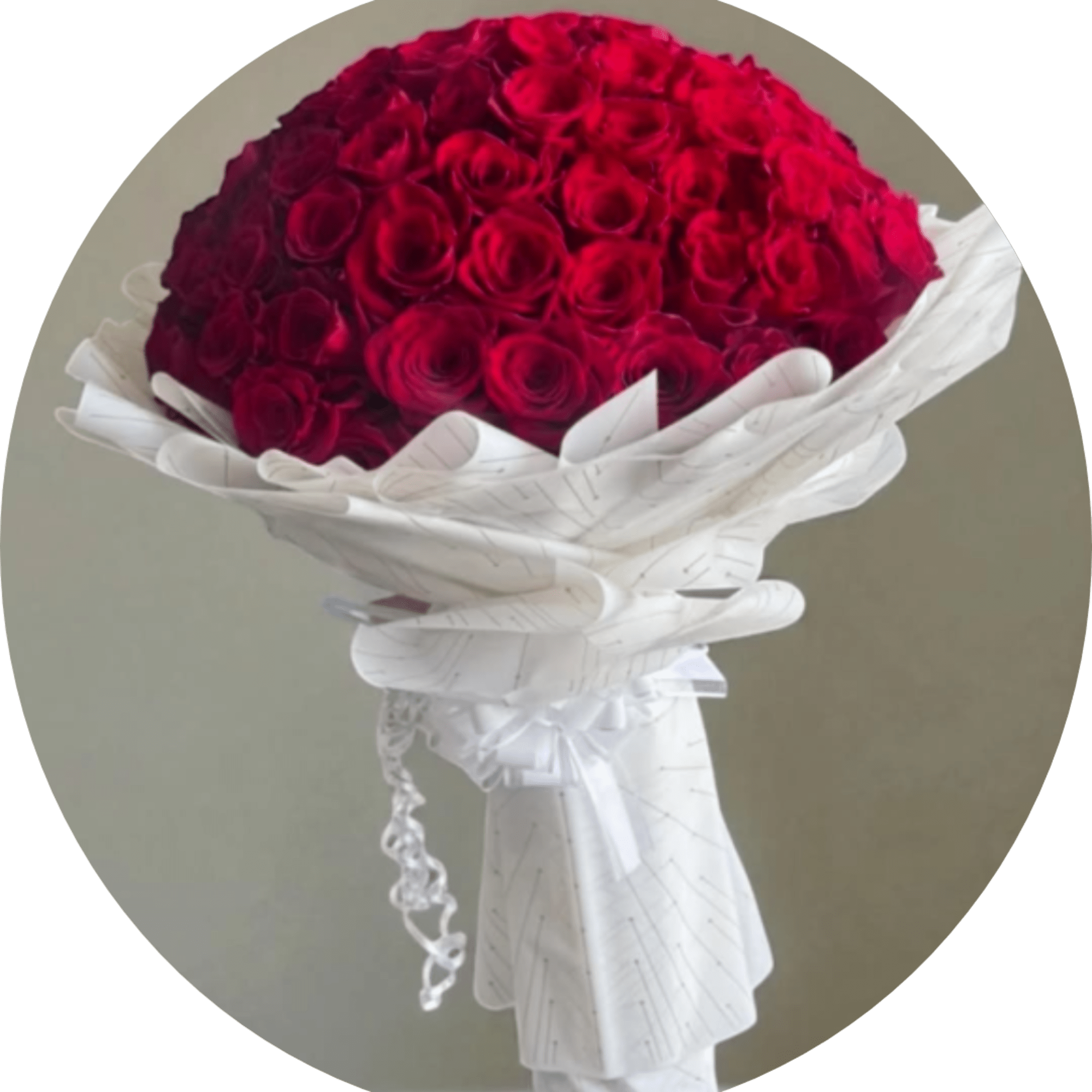 A breathtaking dome of deep red roses wrapped in crisp white paper-this