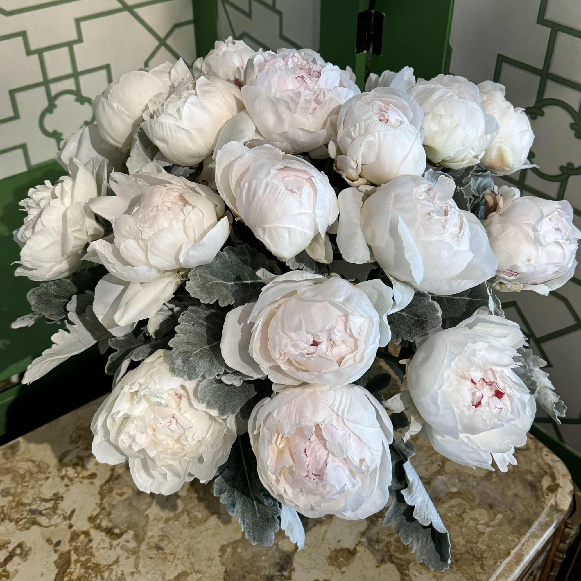 Bouquet of white peonies with gray-green foliage