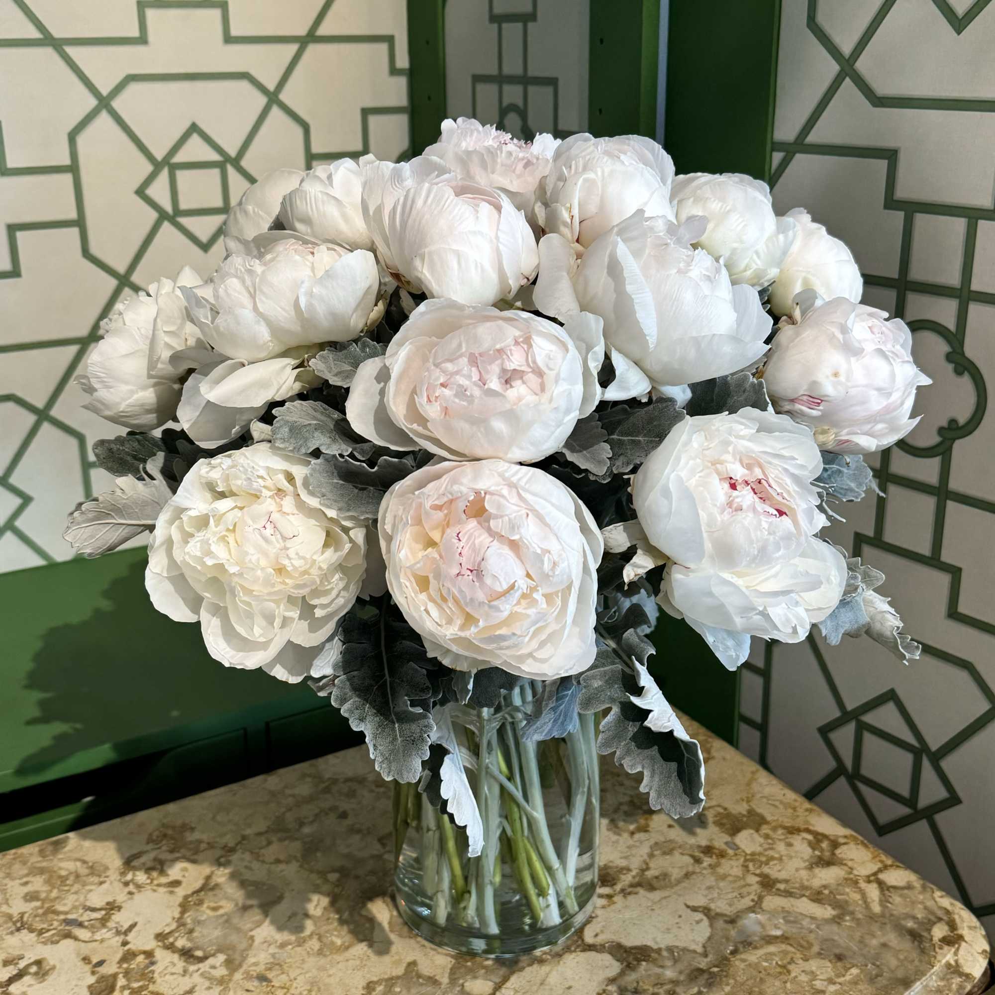 White peony bouquet in a clear glass vase