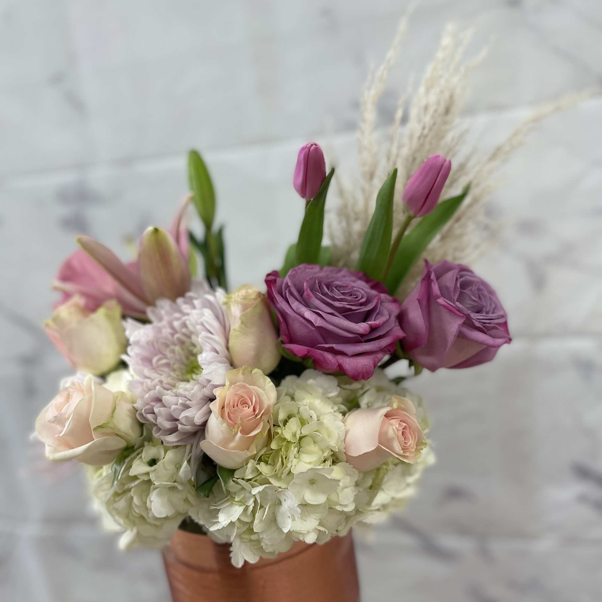 Pink and lavender bouquet in a copper vase