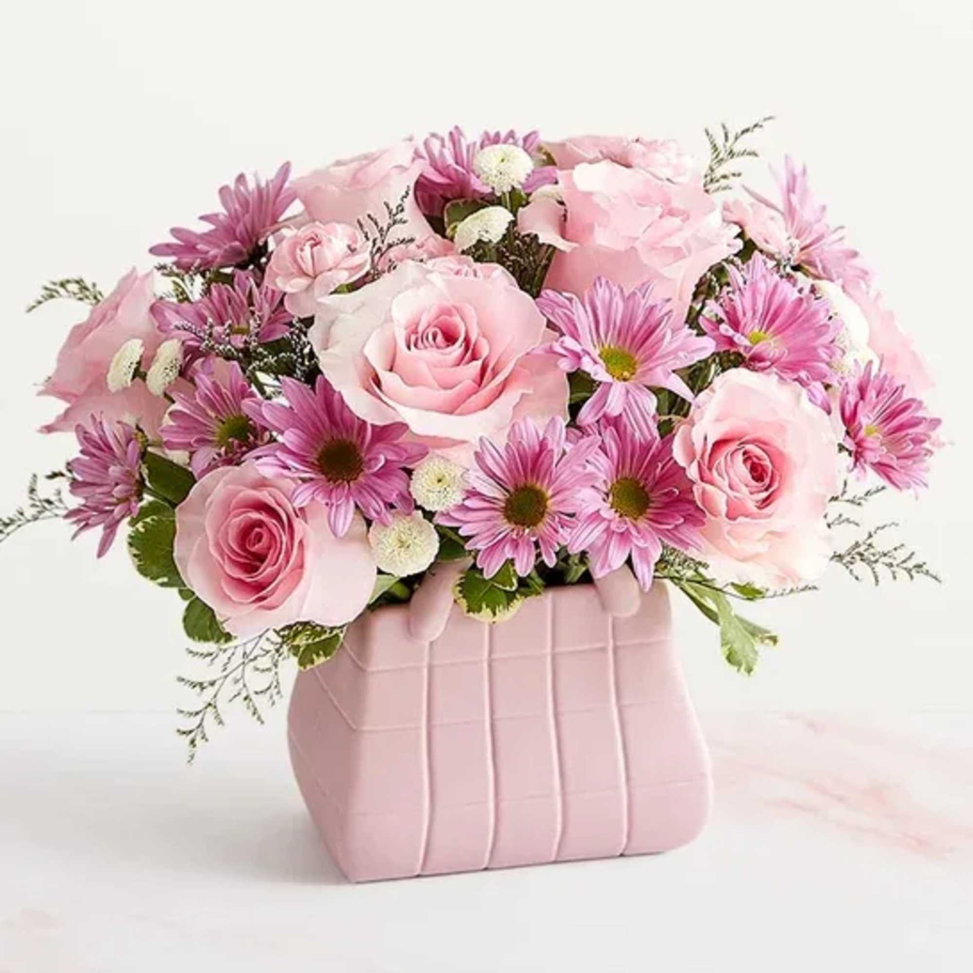 Pink roses and daisy-like flowers in a pink vase