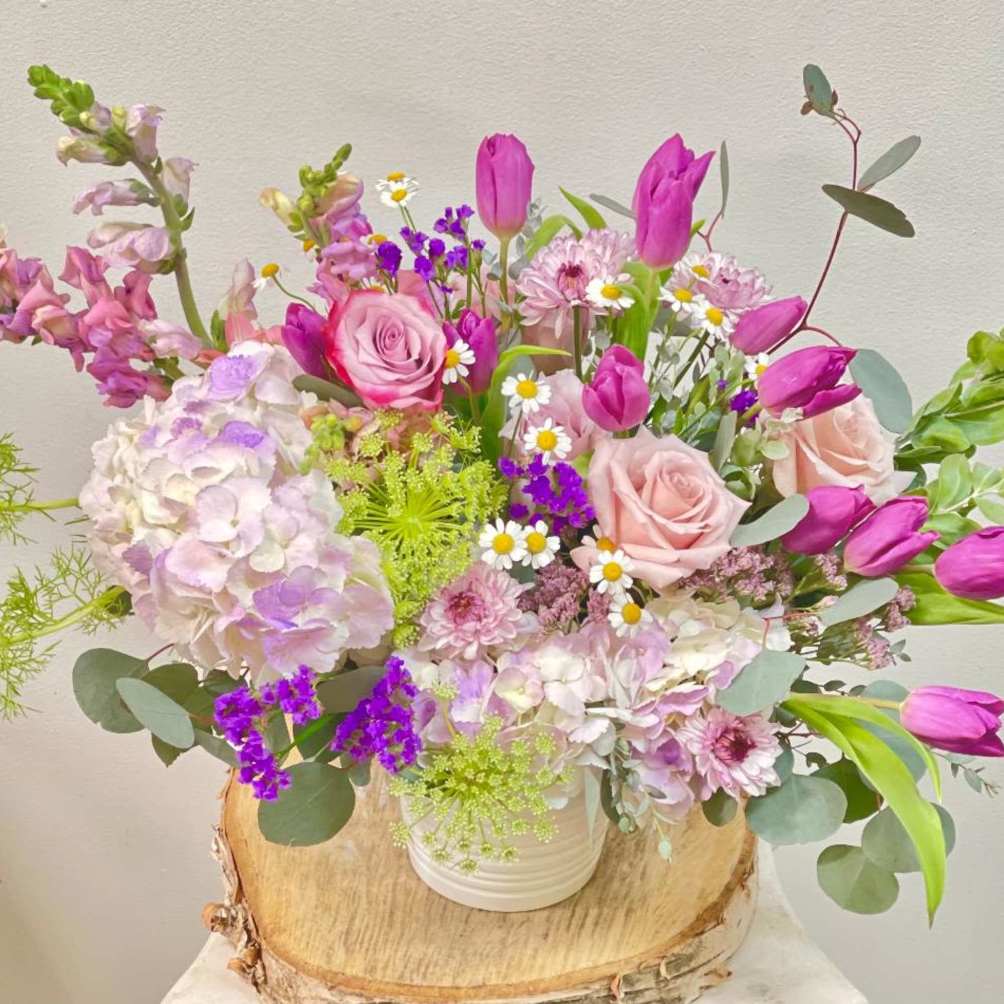 Pink and lavender mixed bouquet in a white vase