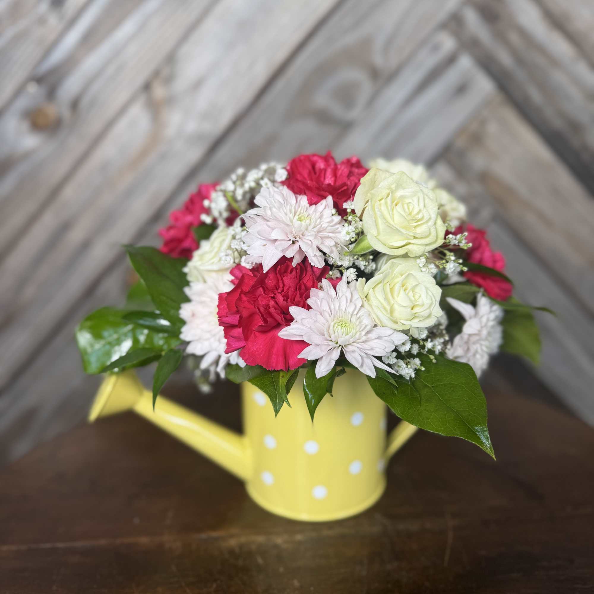 A sweet little watering can filled with love  Designed with fresh