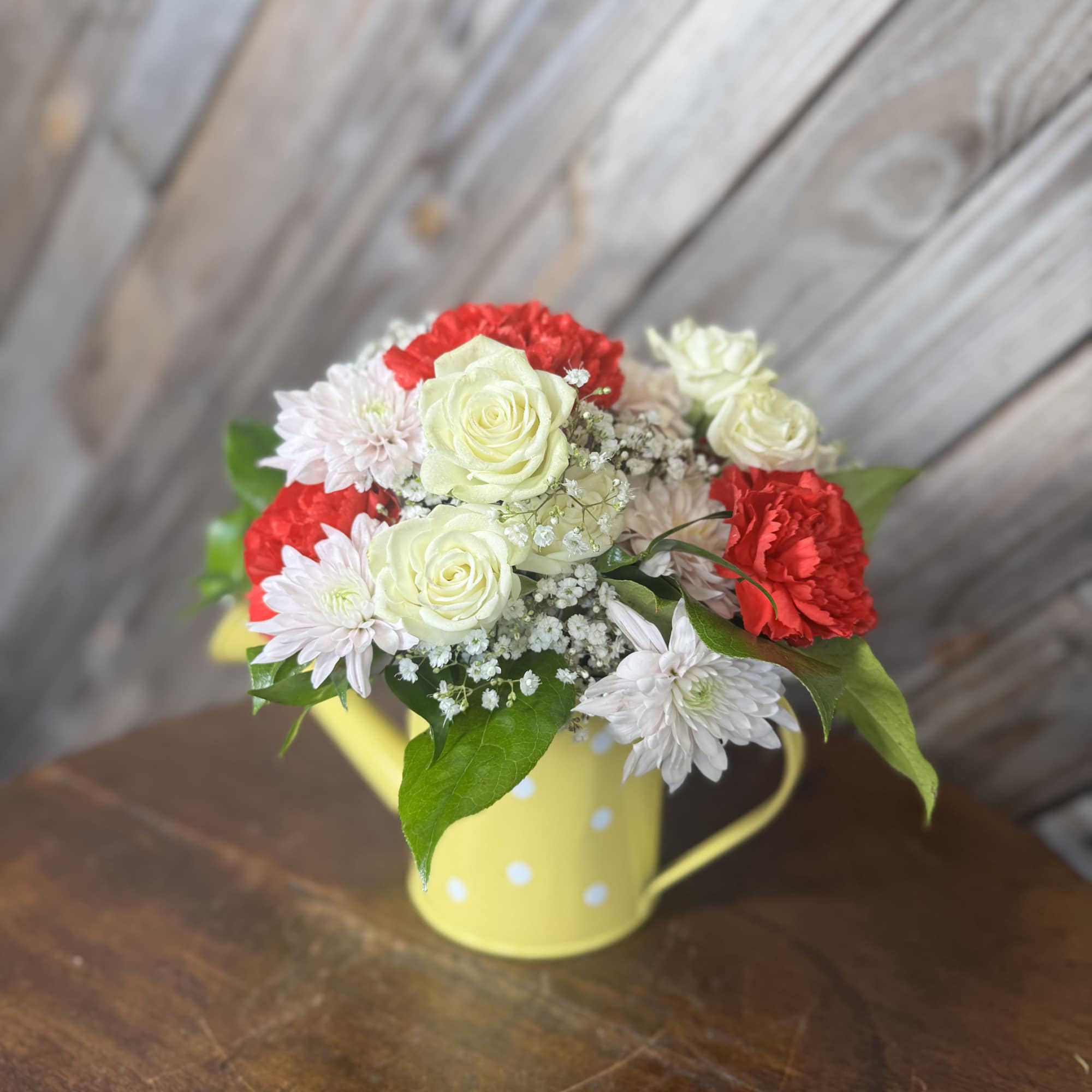 A sweet little watering can filled with love  Designed with fresh