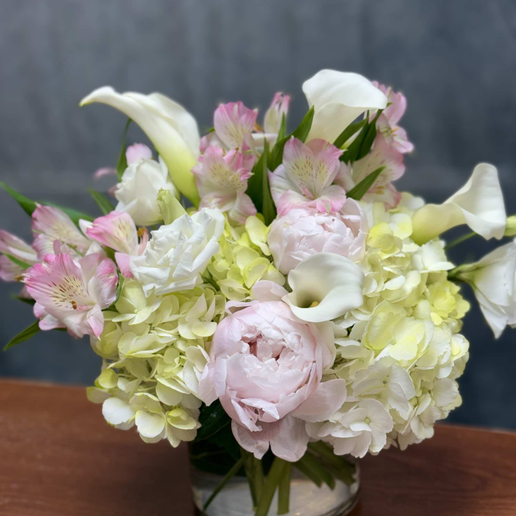 An elegant blend of hydrangeas, peonies , calla Lilies and other beautiful