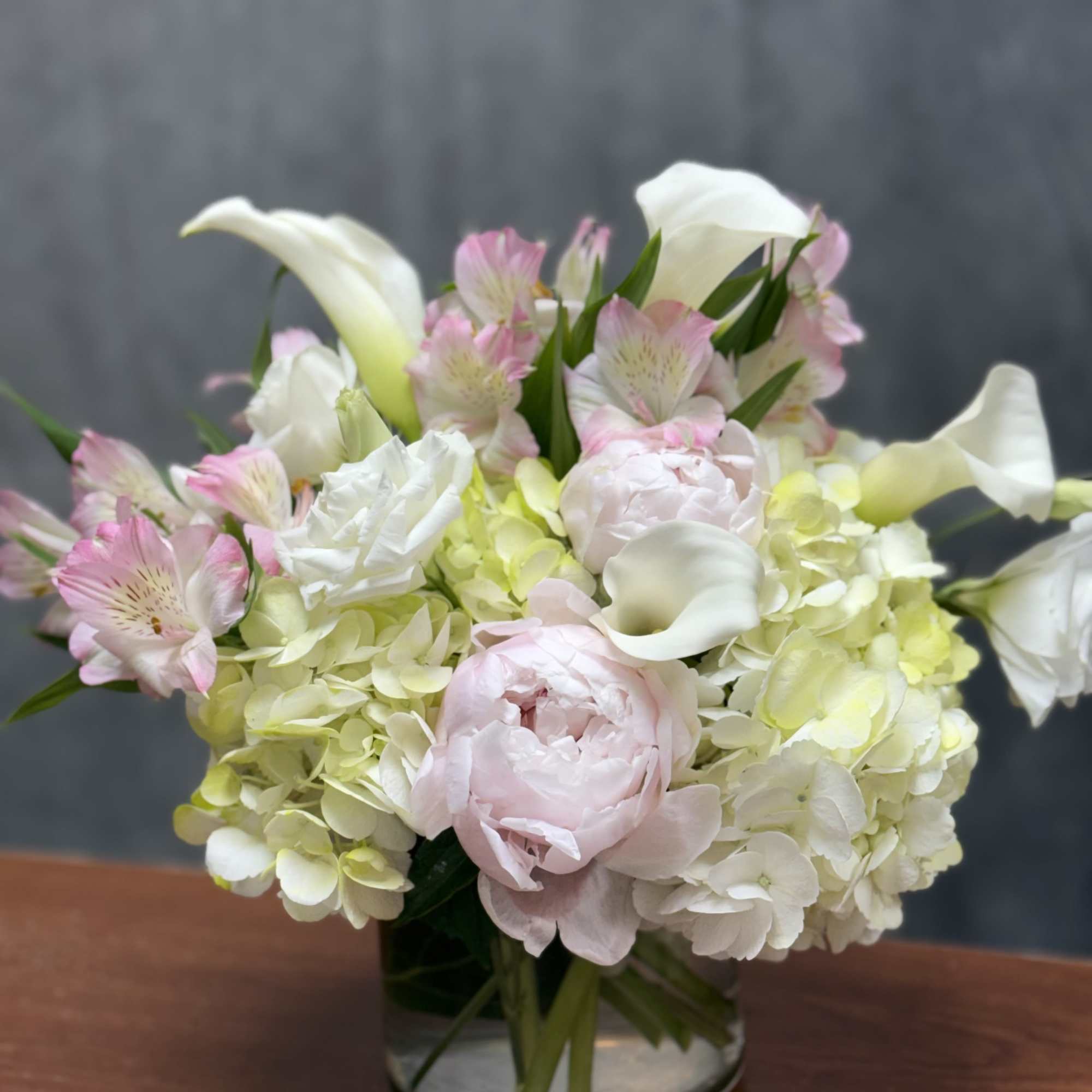 An elegant blend of hydrangeas, peonies , calla Lilies and other beautiful