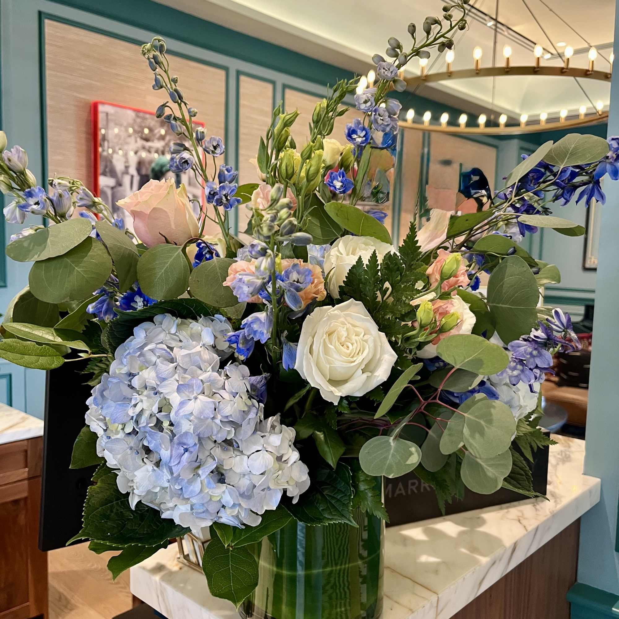 Blue and white floral arrangement in a glass vase
