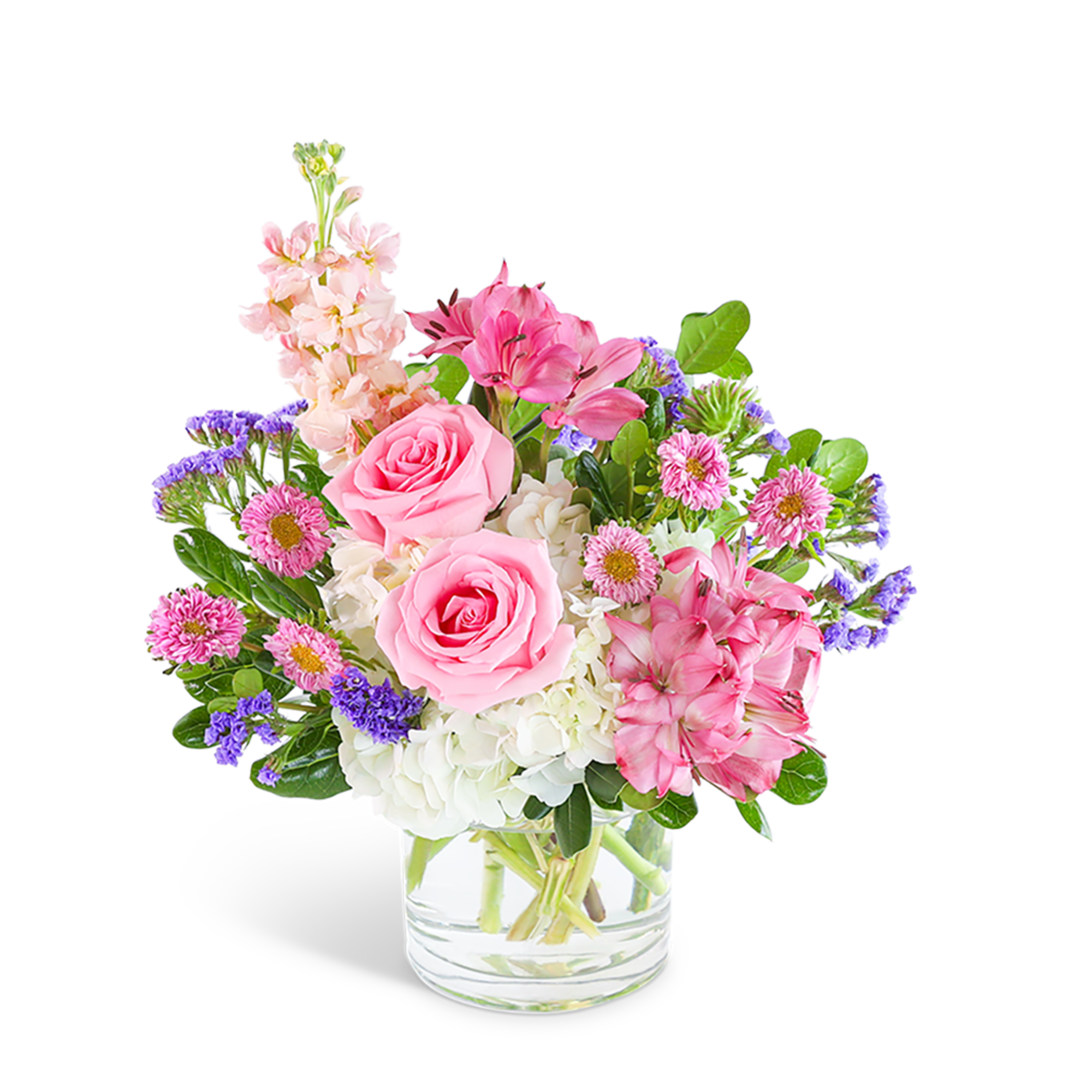 Pink roses and mixed flowers in a clear glass vase
