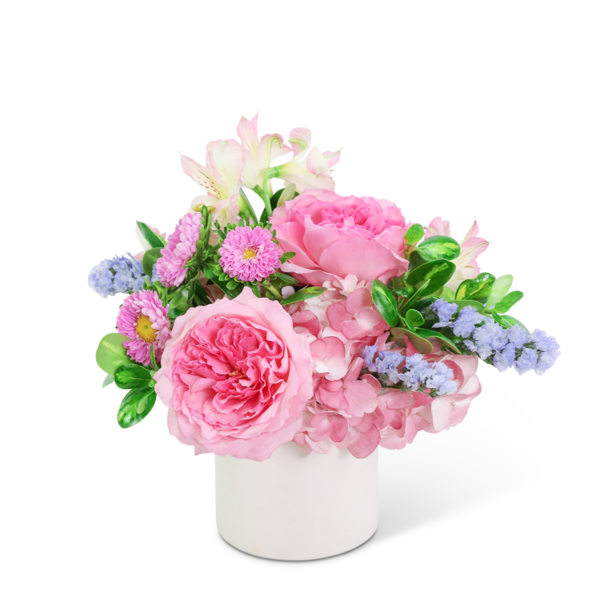 Pink and lavender flowers arranged in a white vase